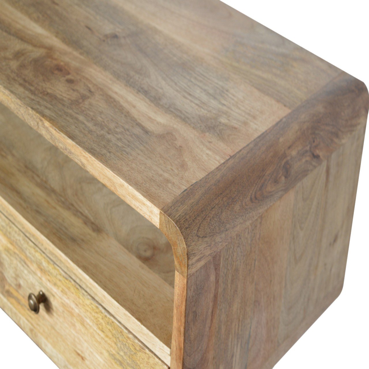 Closeup of a rustic mango wood console table with a curved edge and drawer detail