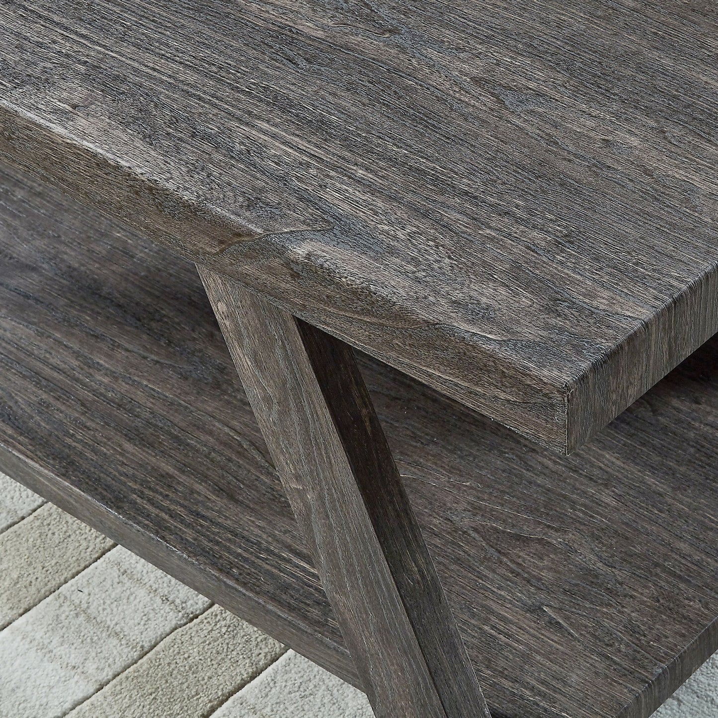 Closeup of a modern grey wood coffee table with a textured finish