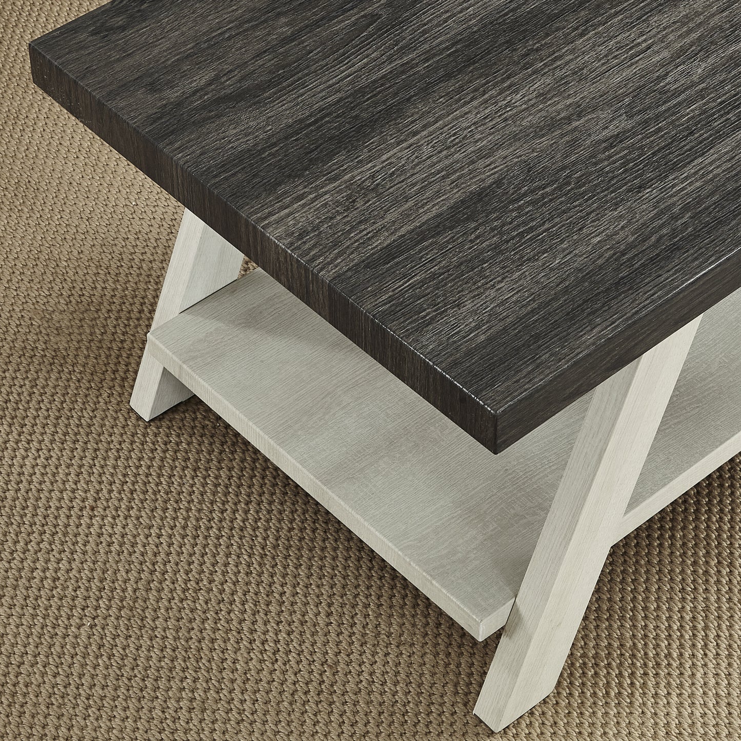 Modern coffee table with dark wood top light wood base and lower shelf