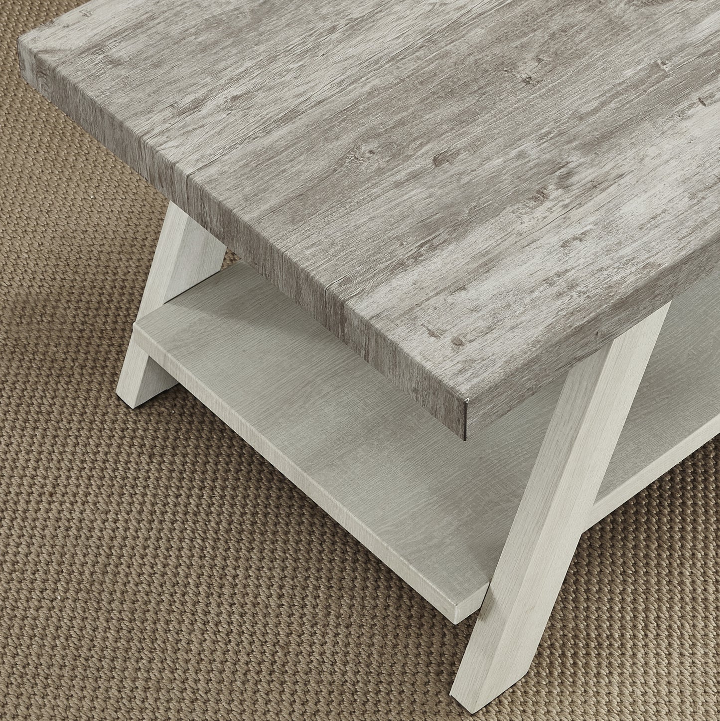 Rustic gray wood coffee table with duallevel shelving on a textured rug