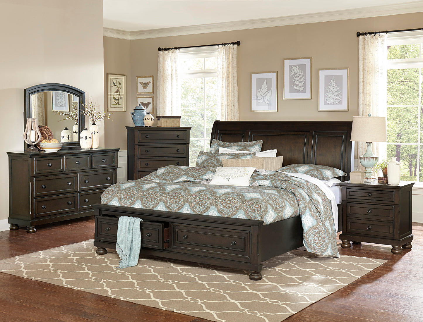 Dark wood sleigh bed with storage drawers and patterned bedding