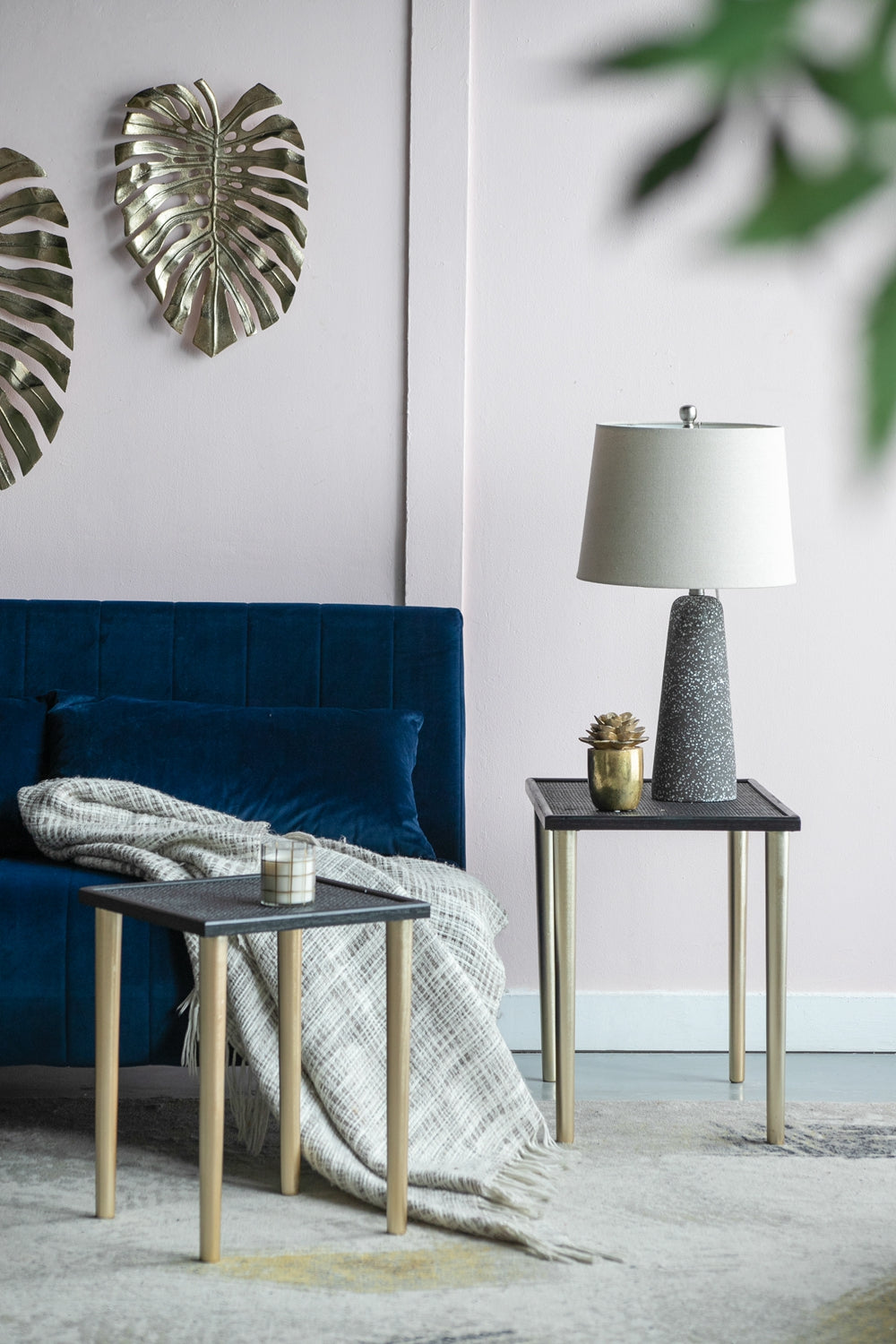 Gold monstera leaf wall art adds tropical flair to a minimalist interior