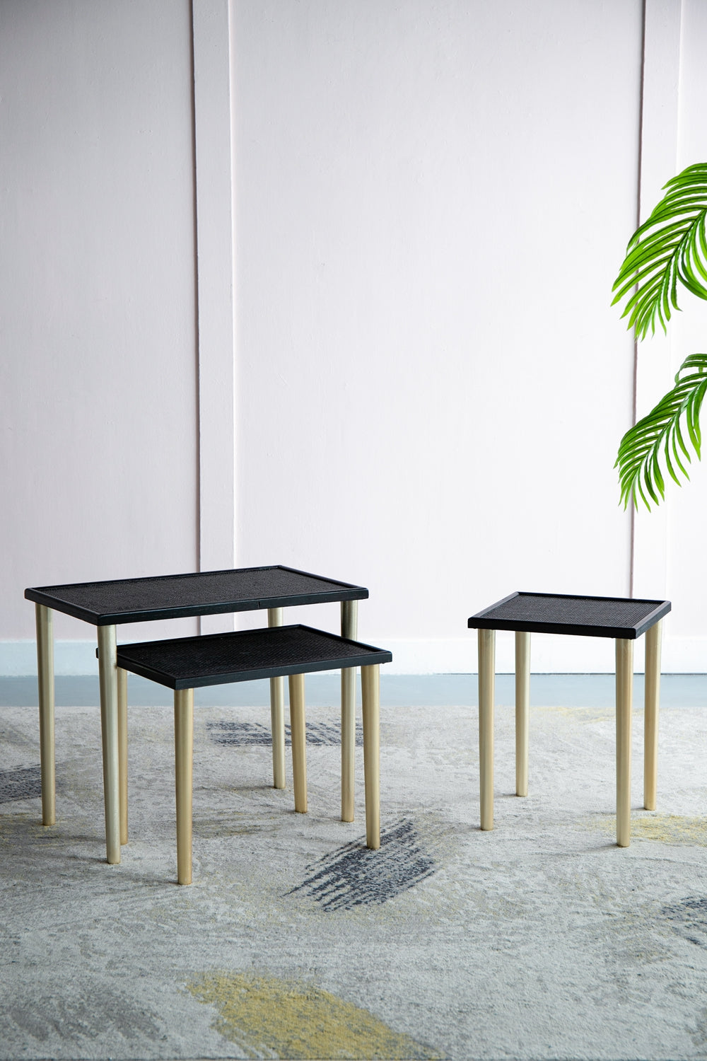 Set of three black nesting side tables with gold legs