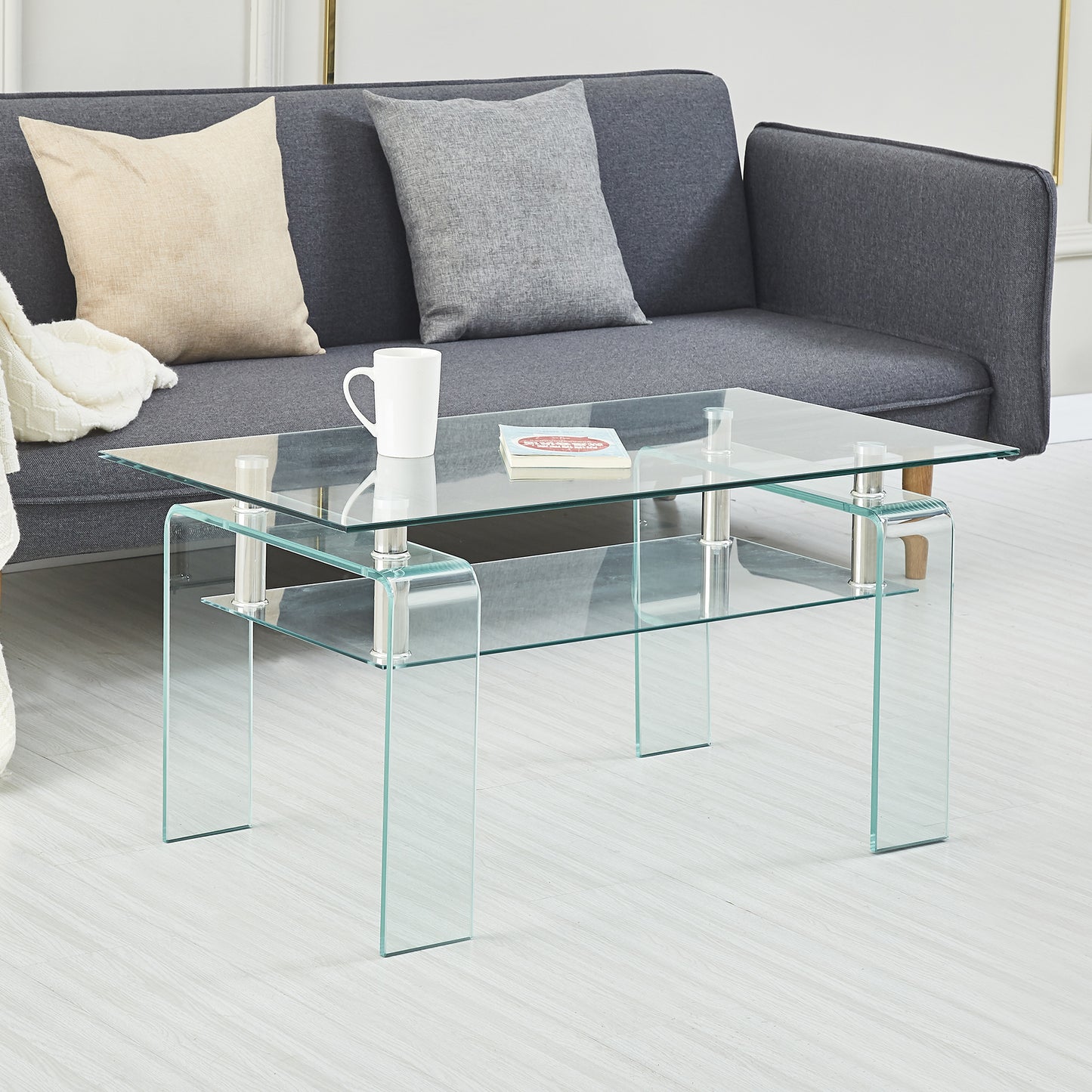 Modern clear glass coffee table with chrome accents and two shelves