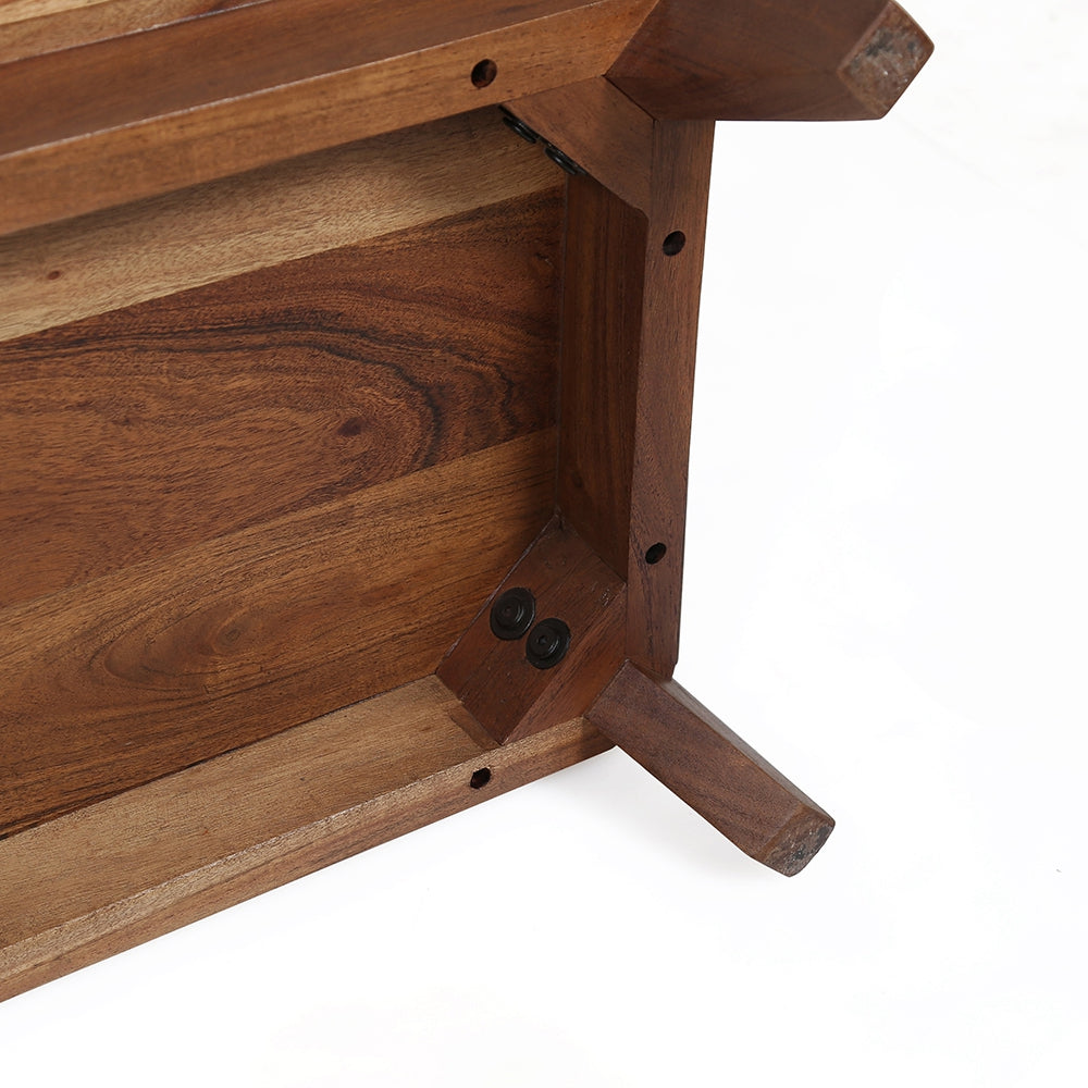 Underside view of a solid wood coffee table showing reinforced joinery and a tapered leg