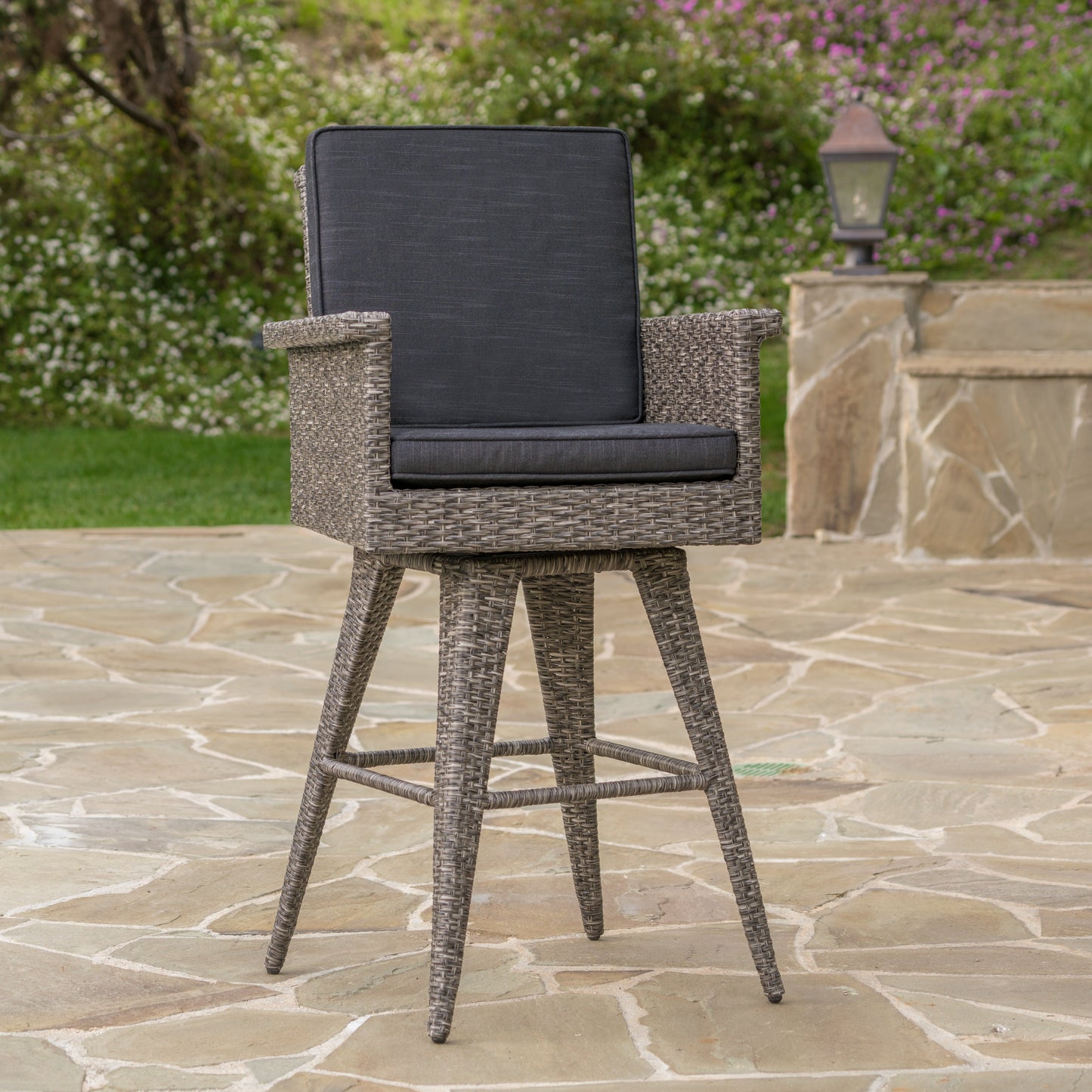 Grey wicker swivel bar stool with dark grey cushions