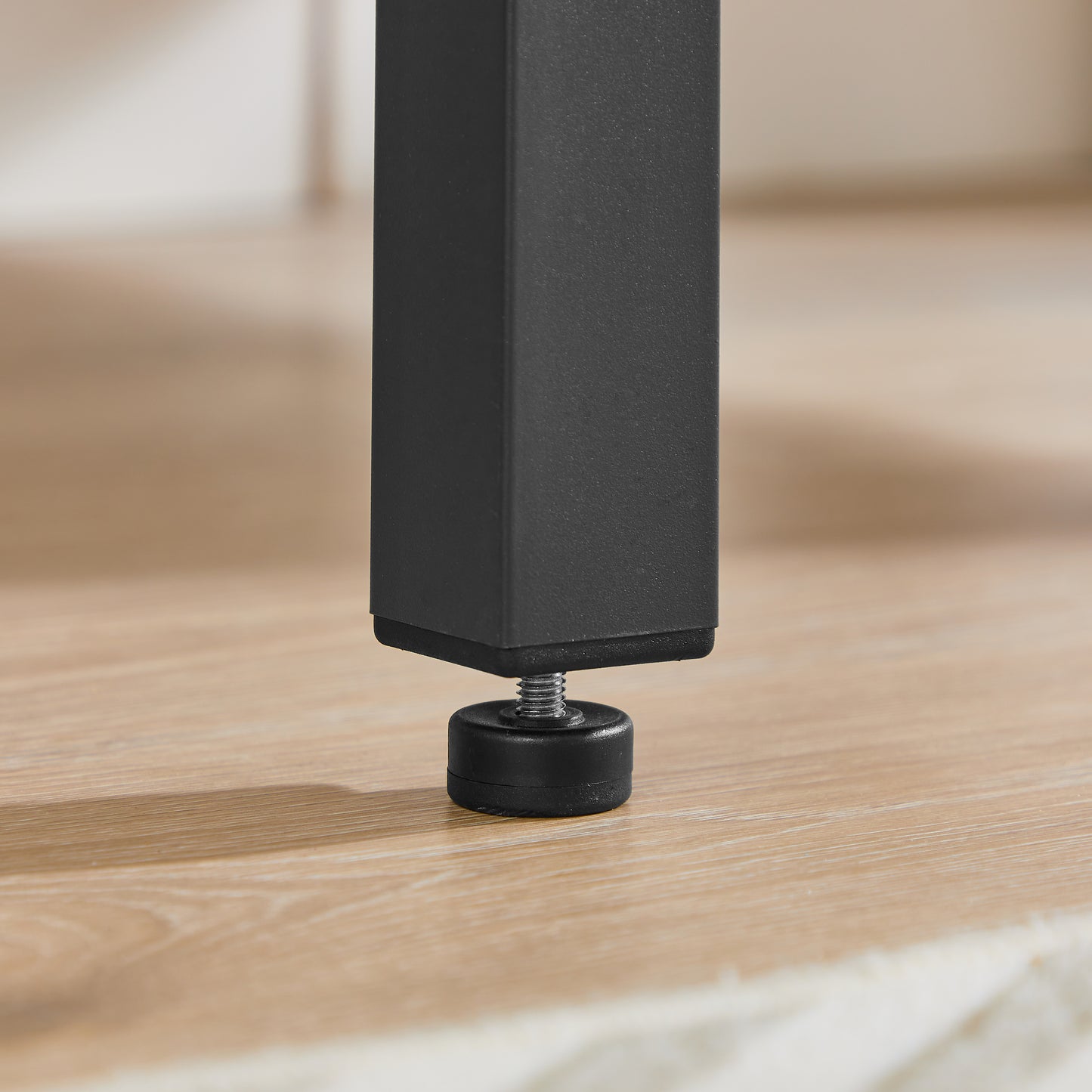 Black metal table leg with adjustable leveling foot