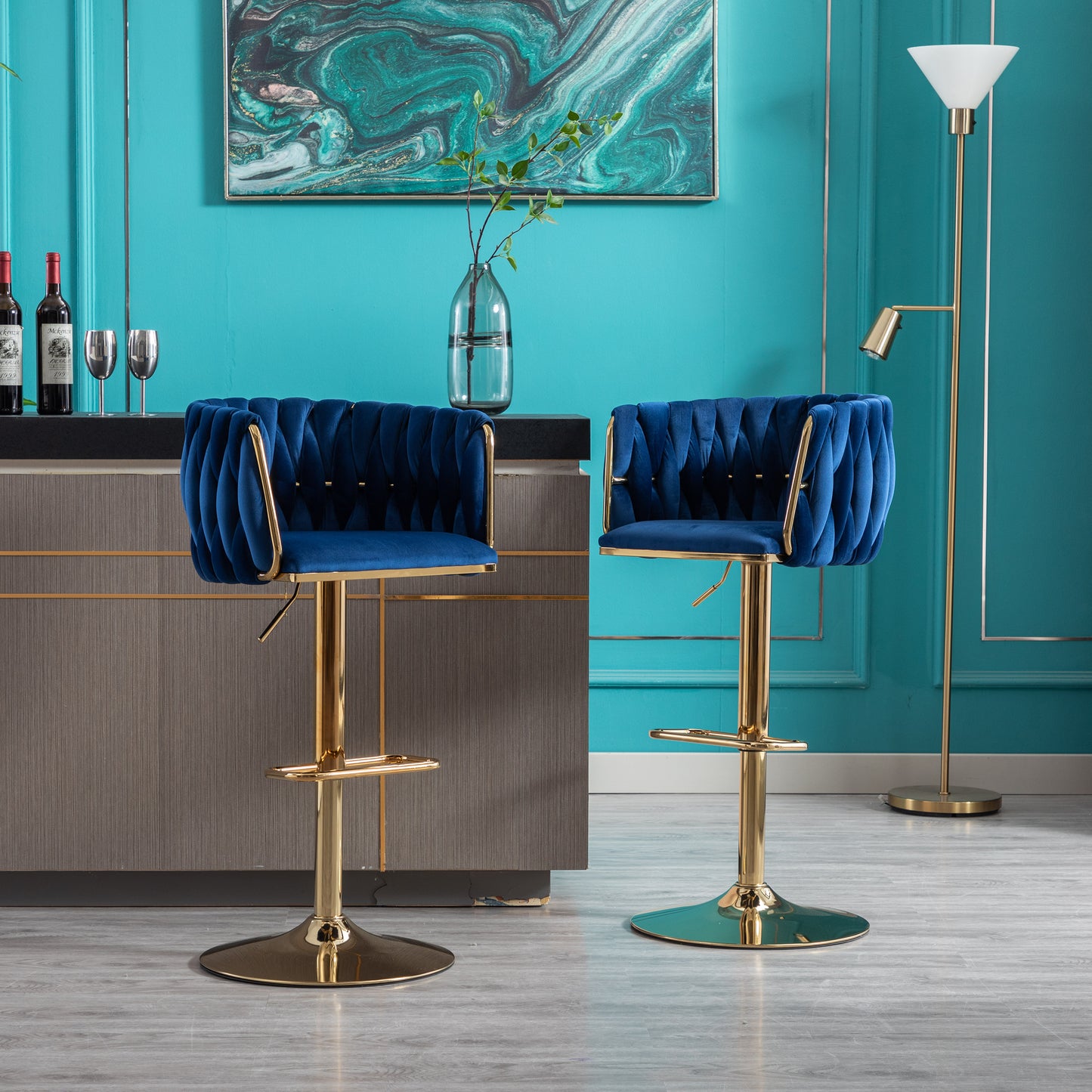 Plush blue velvet bar stool with tufted design and gold accents