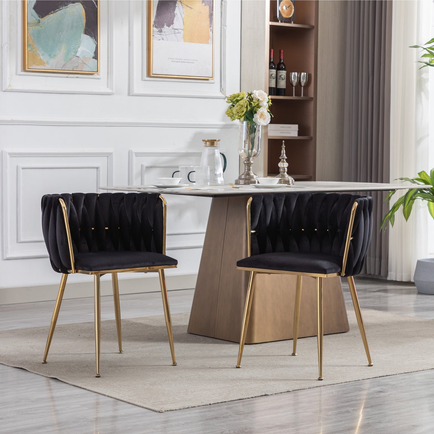 Plush black velvet dining chairs with gold legs and tufted detailing