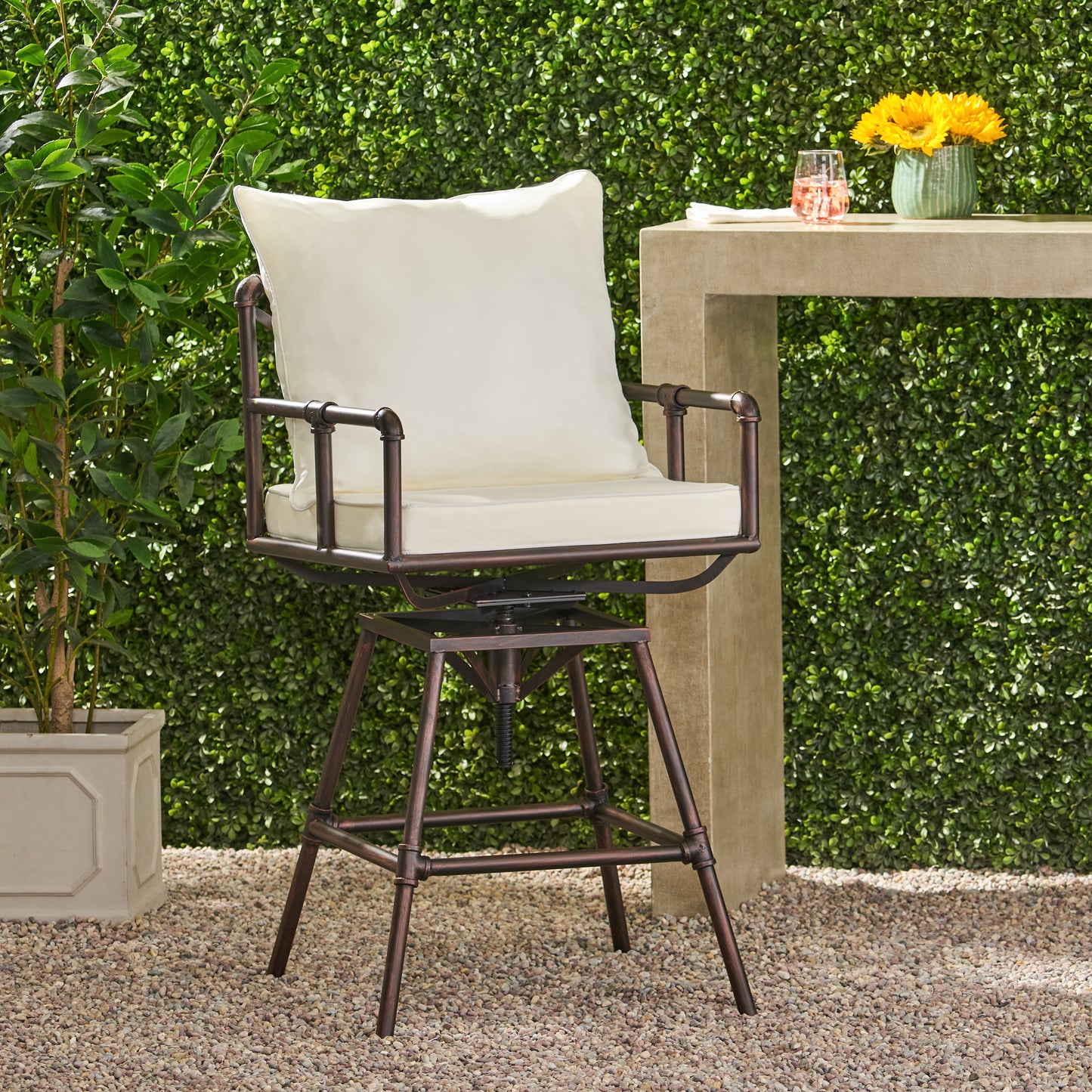 Rustic bronze metal swivel bar stool with cream cushions