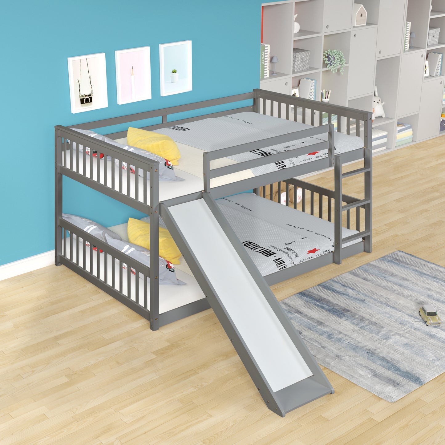 Gray wooden twin over twin bunk bed with slide and yellow pillows