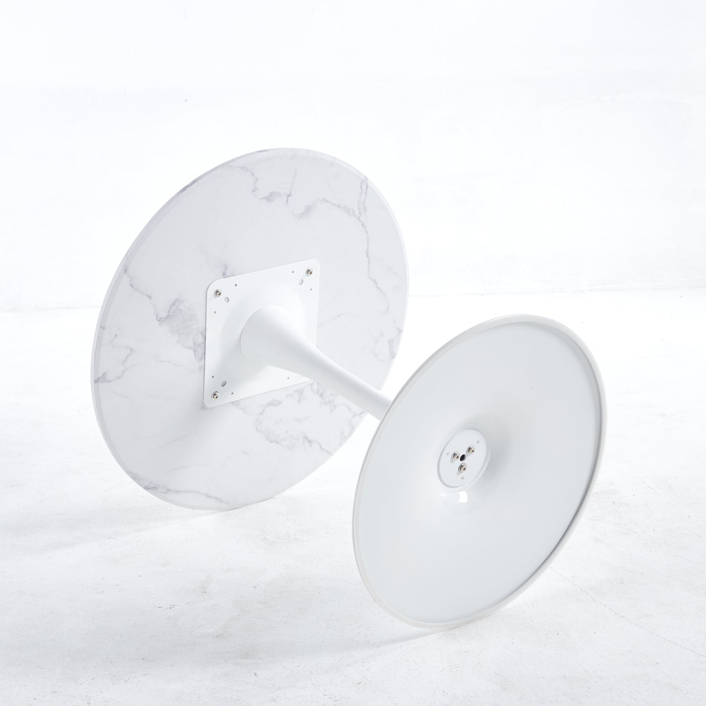 White marble round tabletop with brushed metal tulip base angled view for assembly