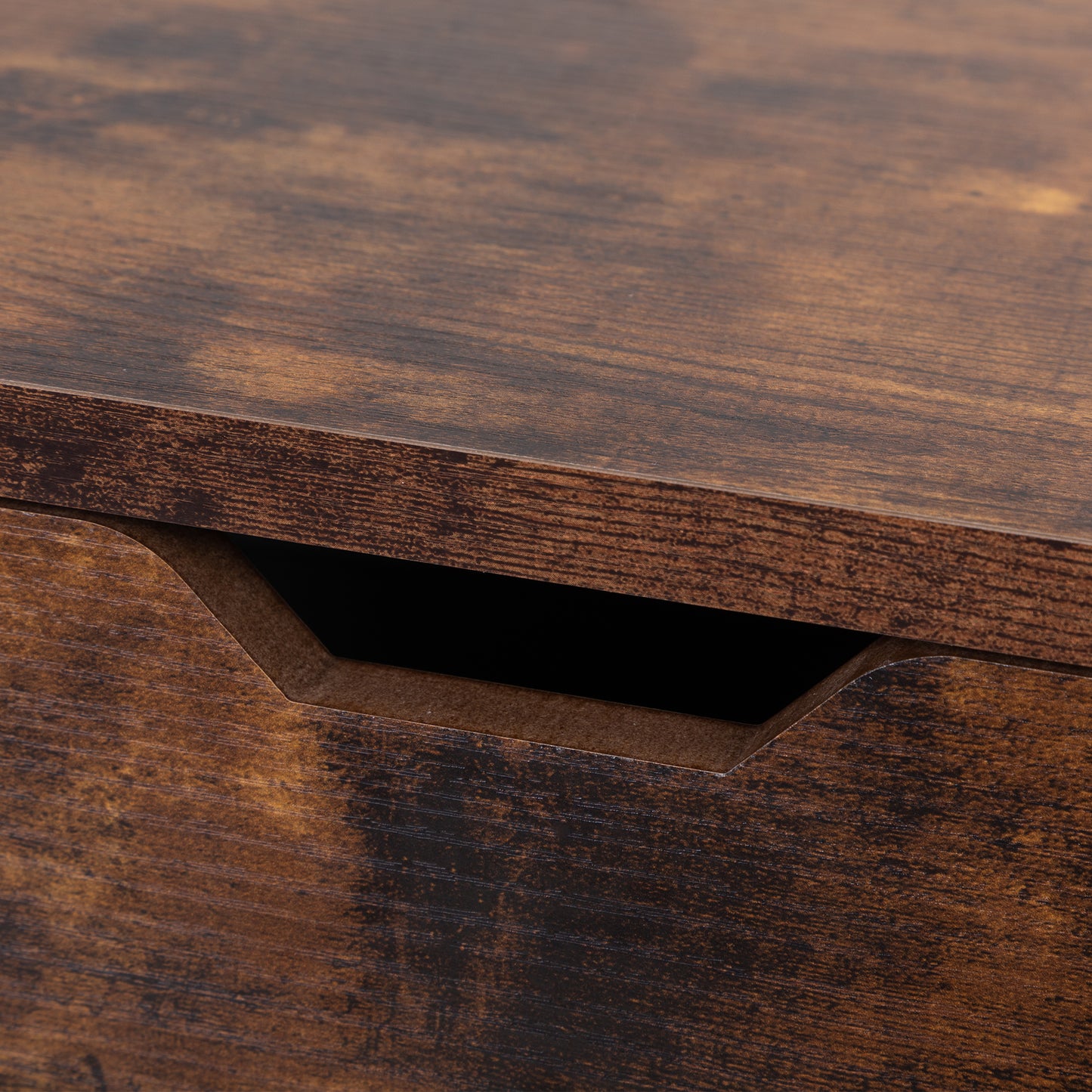 Rustic brown wood grain texture on a drawer front with a carved handle recess
