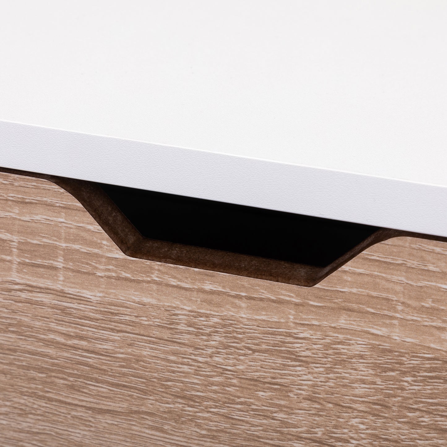 Closeup of a modern furniture drawer front with integrated handle and wood grain effect