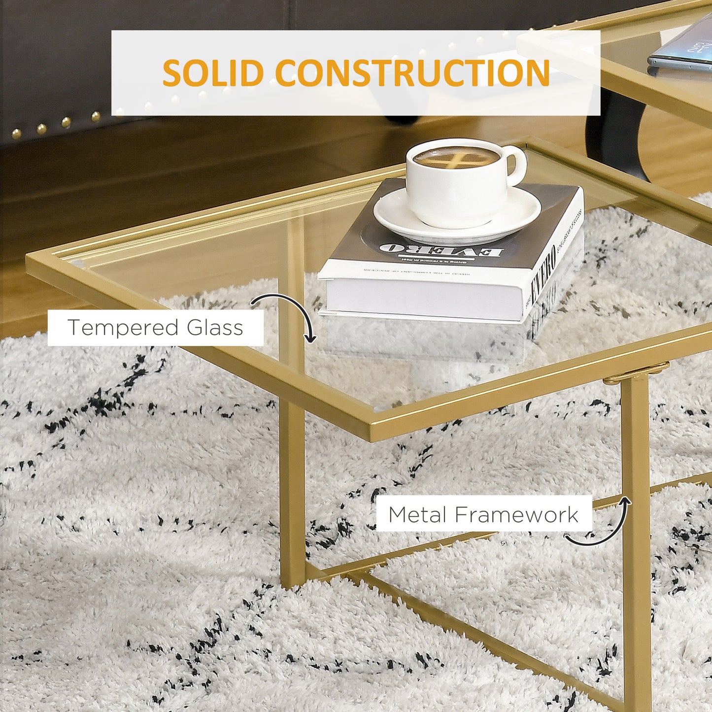 Gold metal frame coffee table with tempered glass top and a cup of coffee