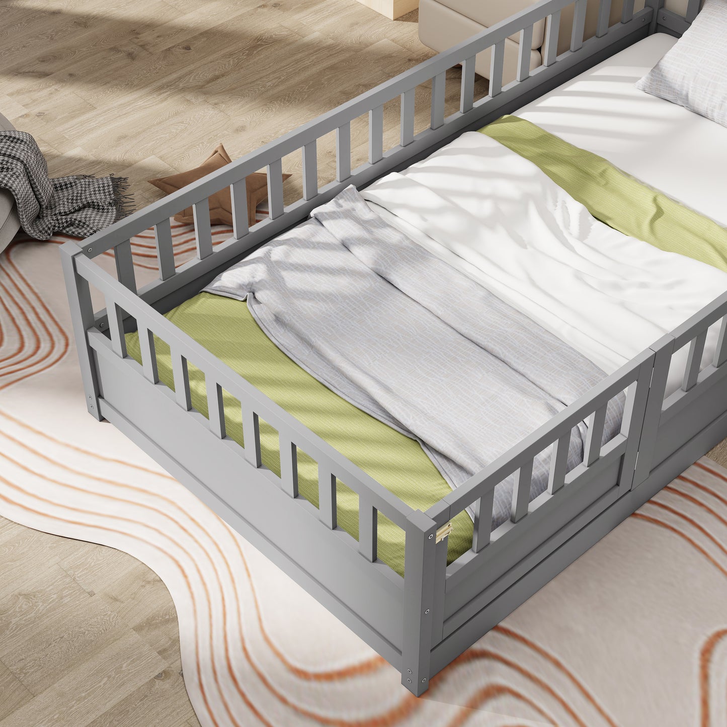 Grey wooden toddler bed with protective rails and white bedding