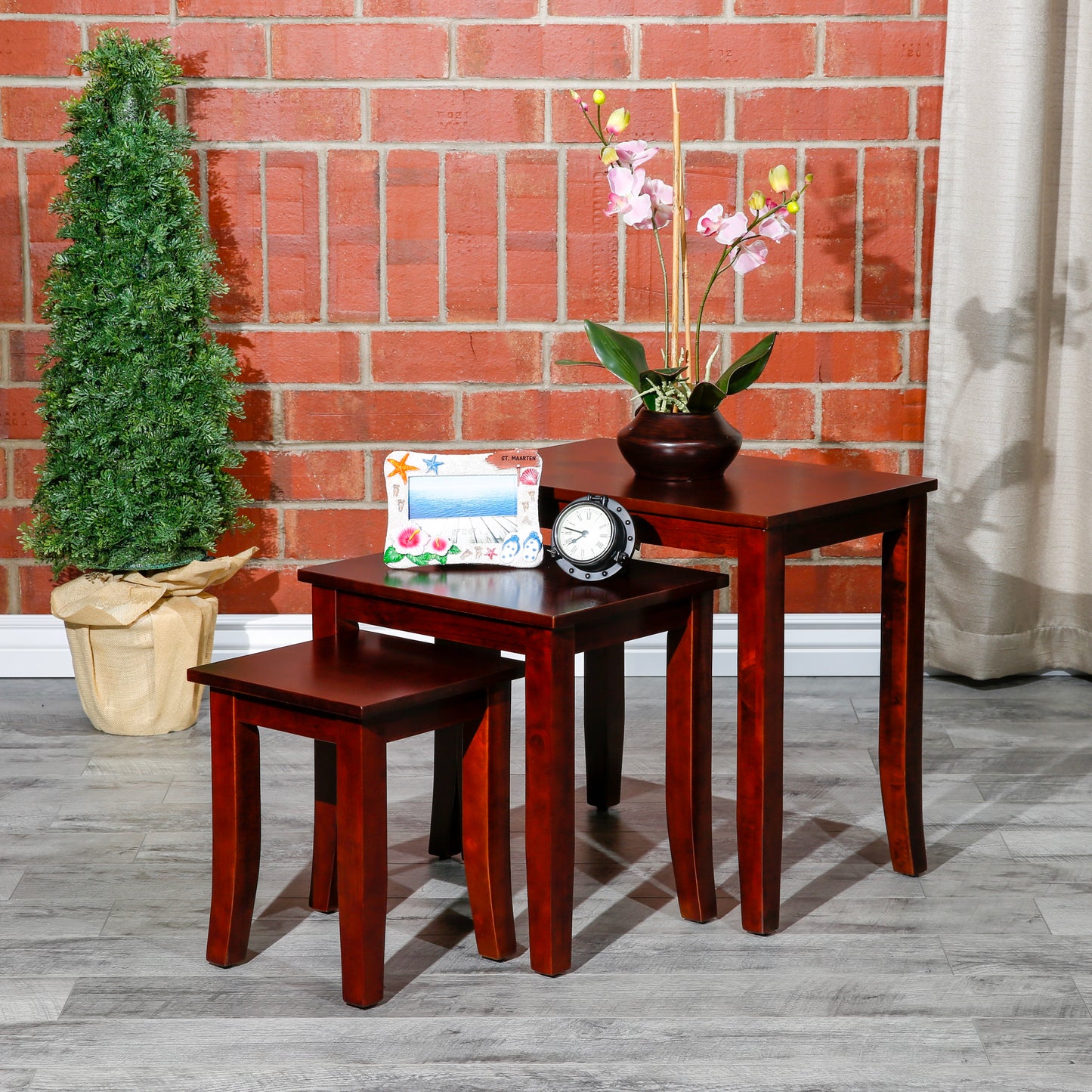 Dark cherry wood nesting tables in varying sizes with curved legs