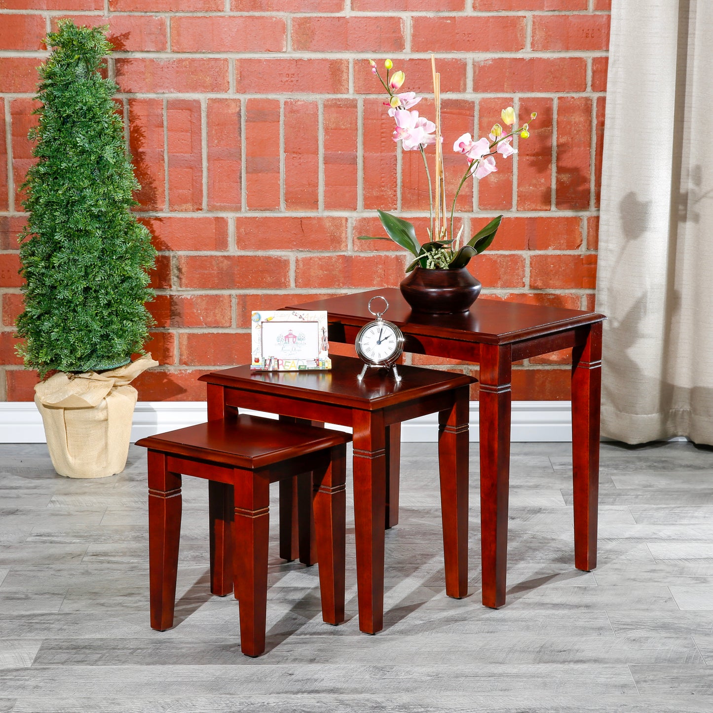 Three mahogany nesting tables with classic design perfect for small spaces