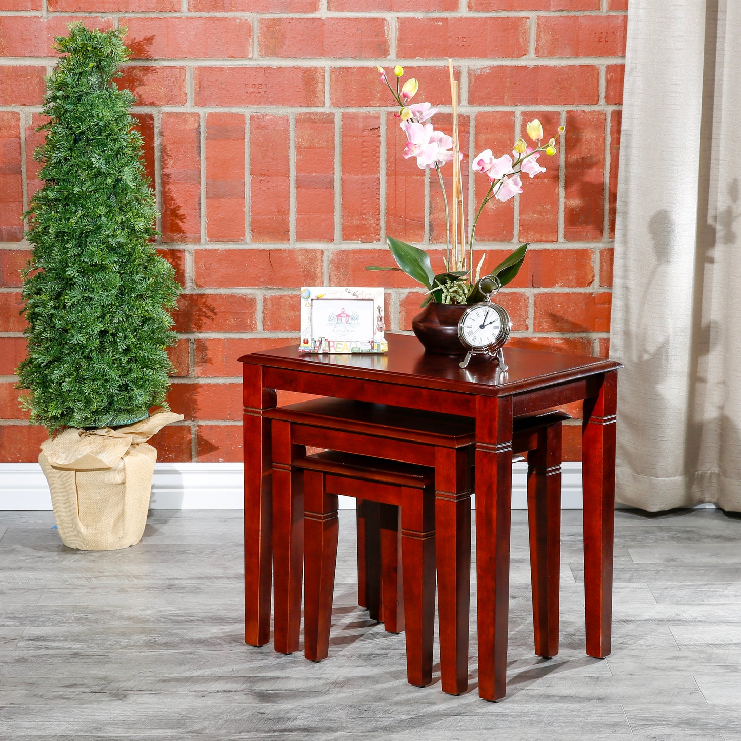 Rich cherry wood nesting tables offer versatile display and storage solutions