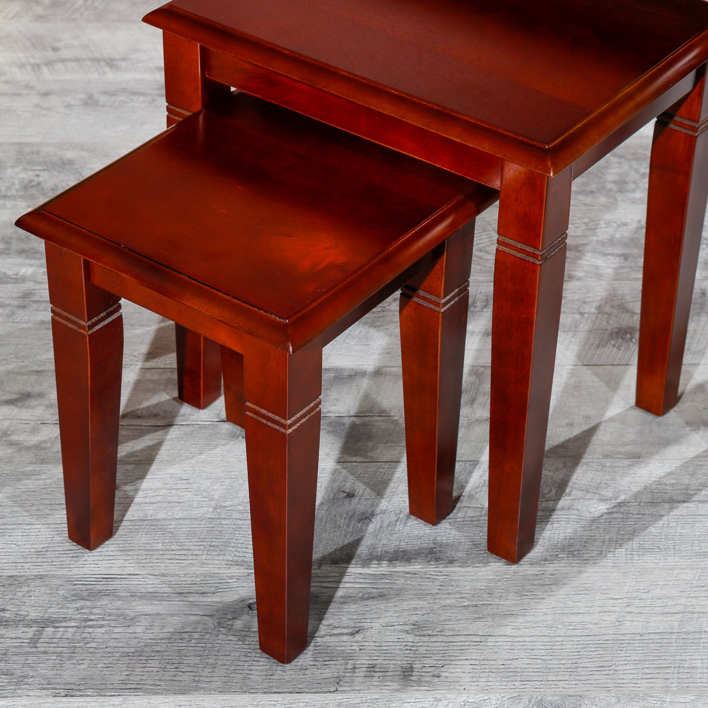 Cherry wood nesting tables set of with decorative carved legs and a smooth finish