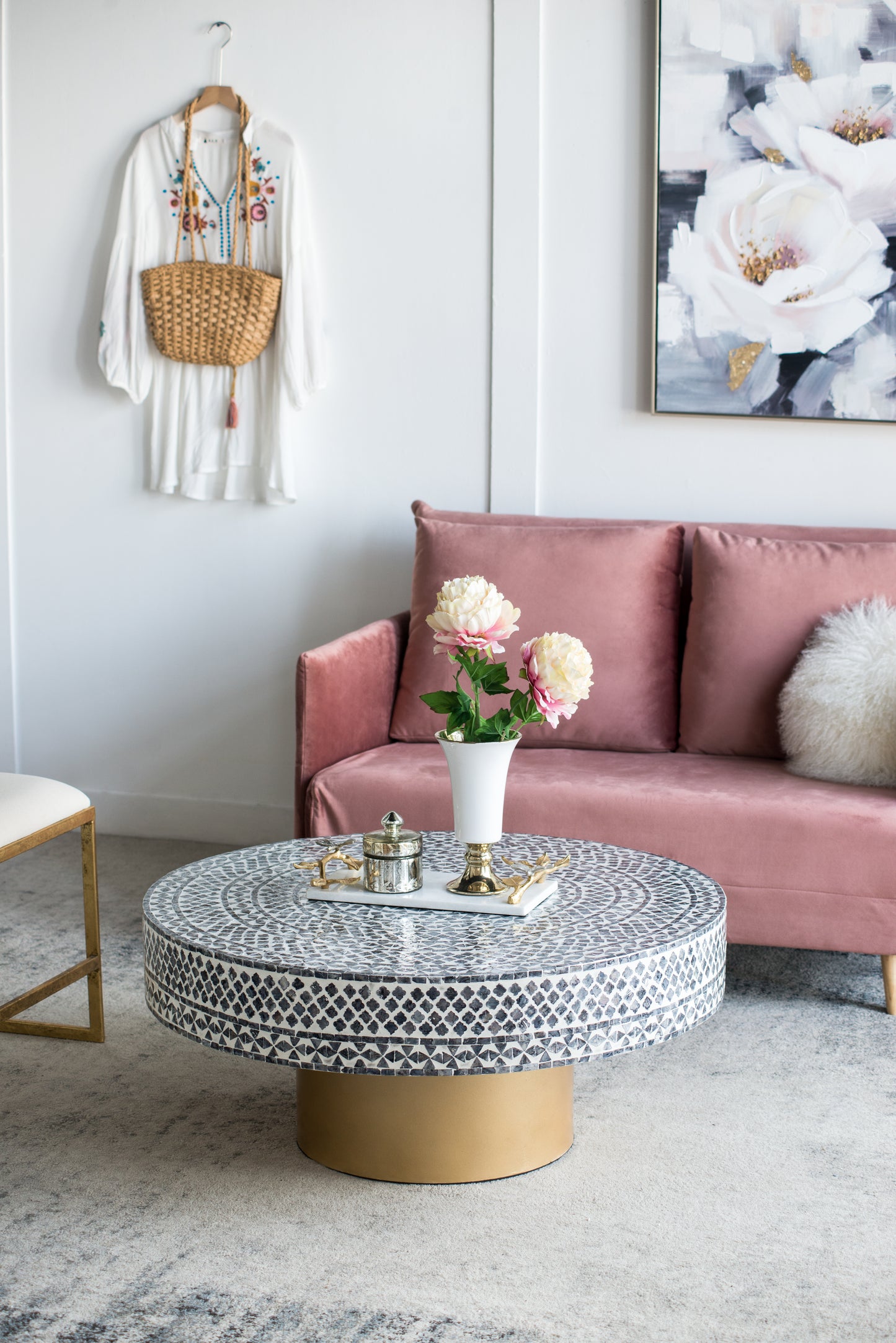 Dusty rose velvet sofa with white textured throw pillow