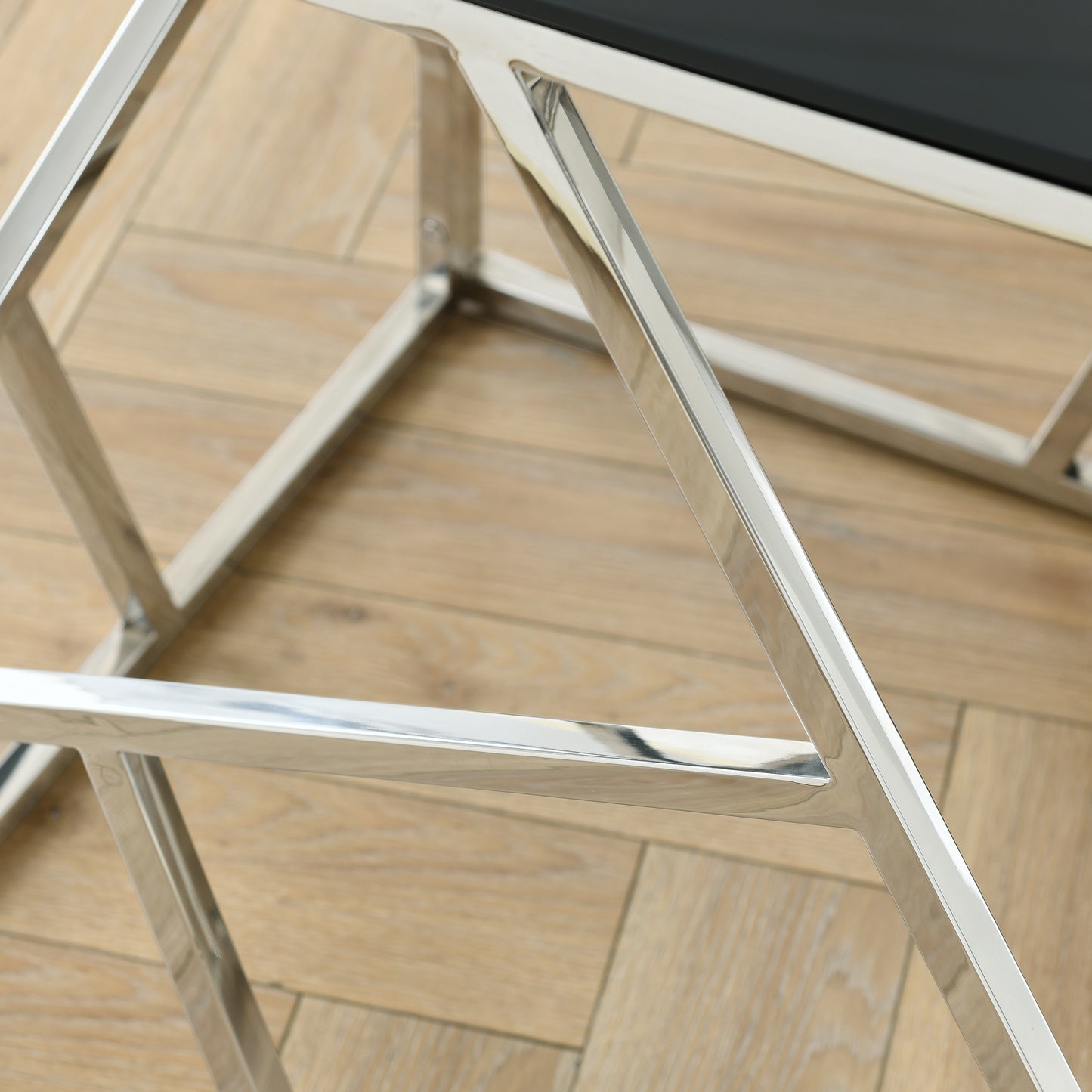Closeup of a polished chrome geometric base for a modern coffee table