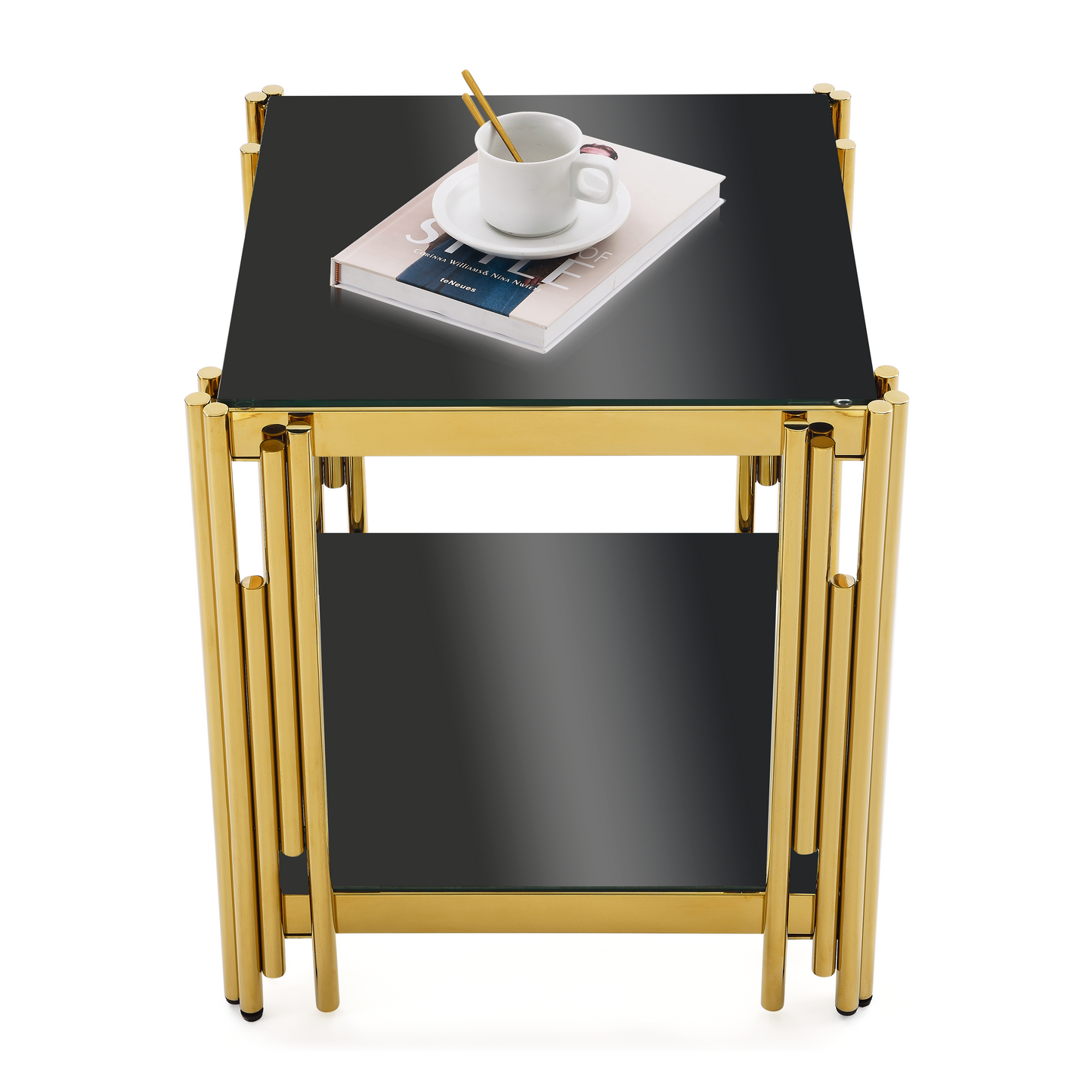 Modern black glass side table with a sleek gold metal frame and a cup of coffee