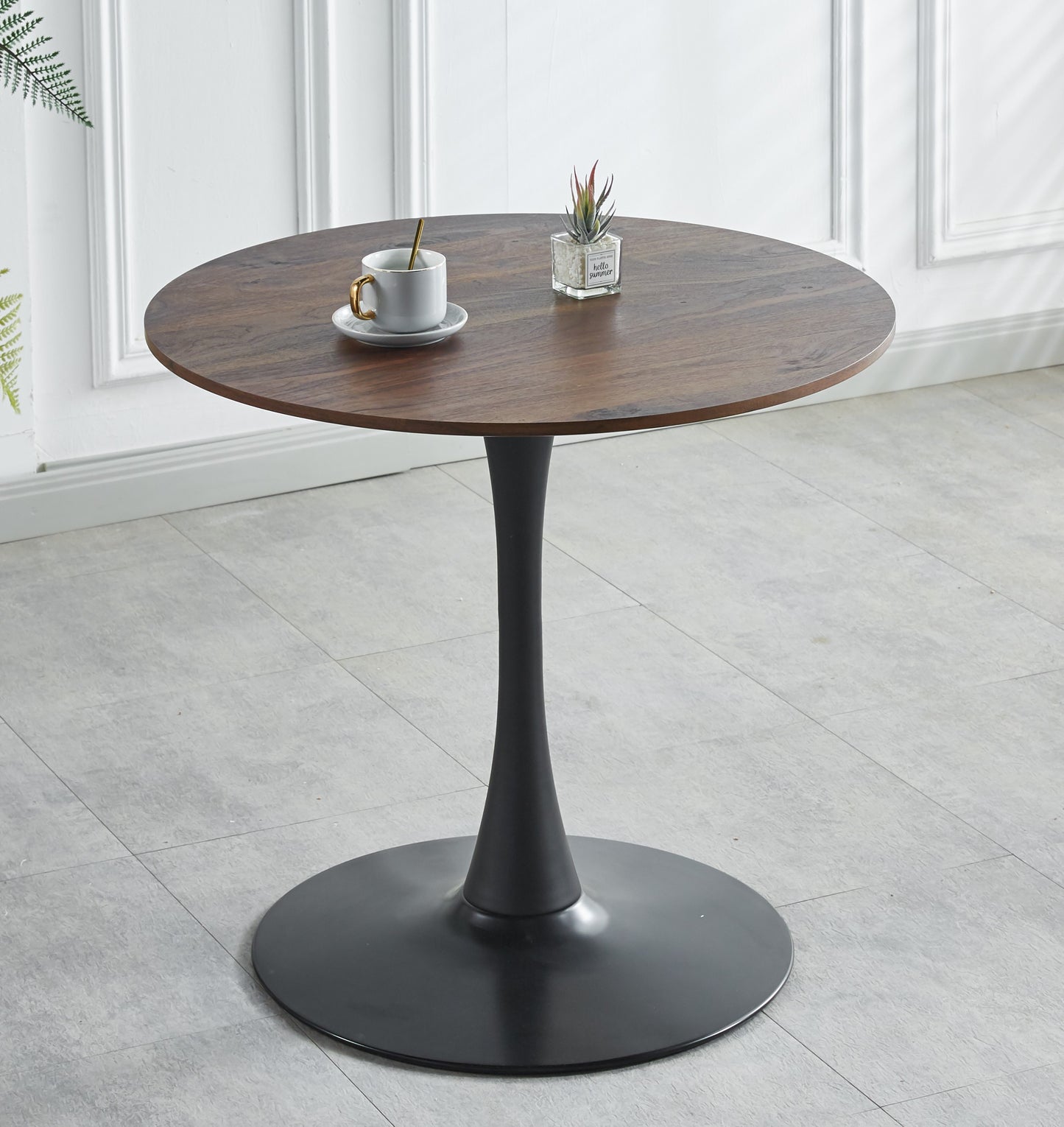 Round walnut dining table with black tulip base perfect for modern kitchens