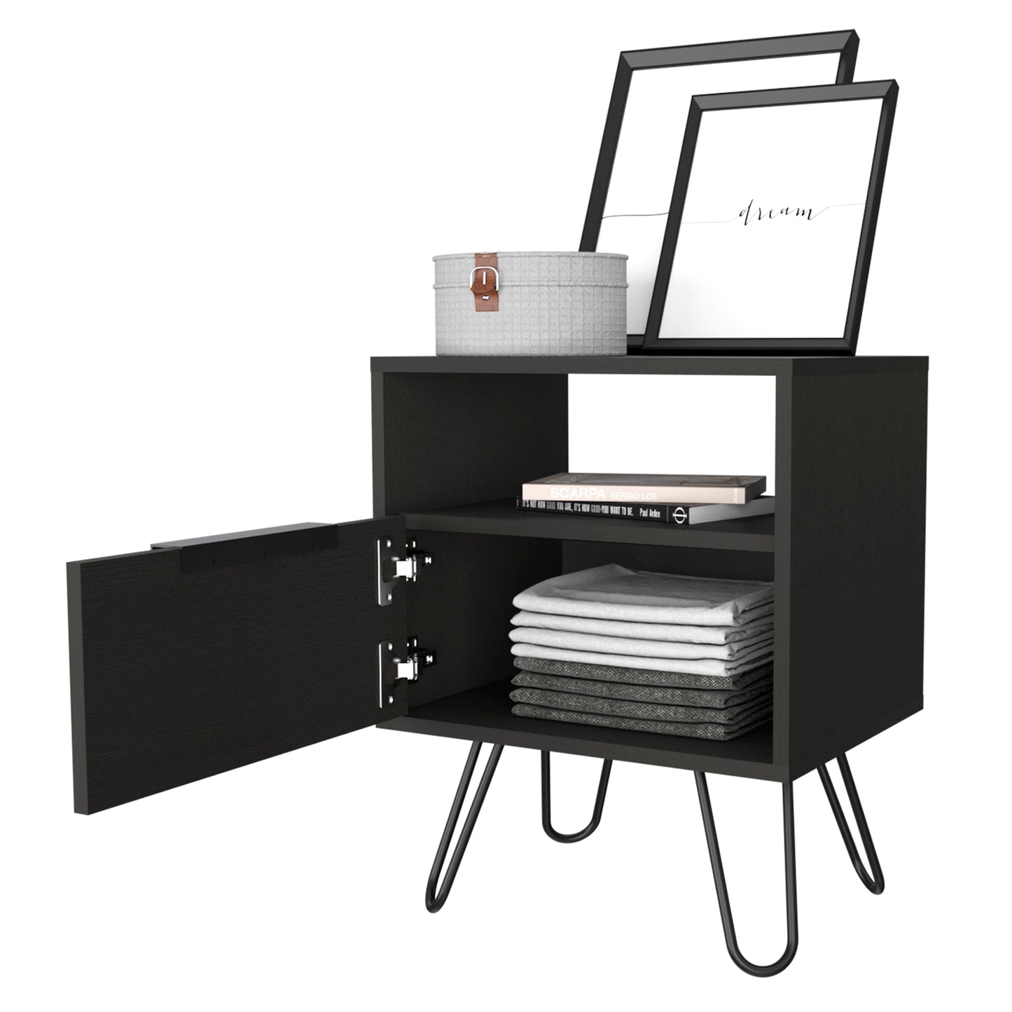 Black bedside table with open cabinet door displaying folded linens and books