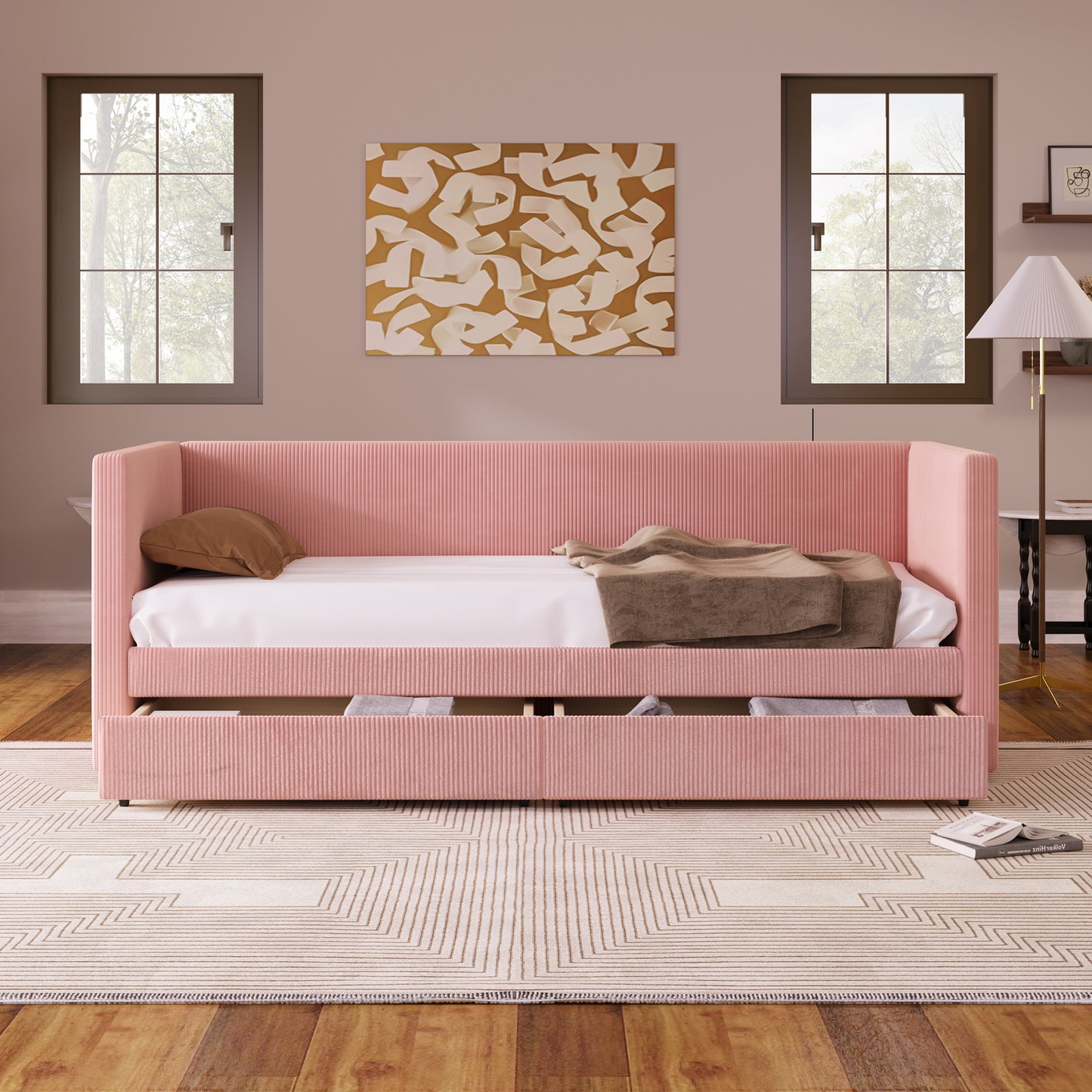 Pink corduroy daybed with storage drawers and a brown pillow