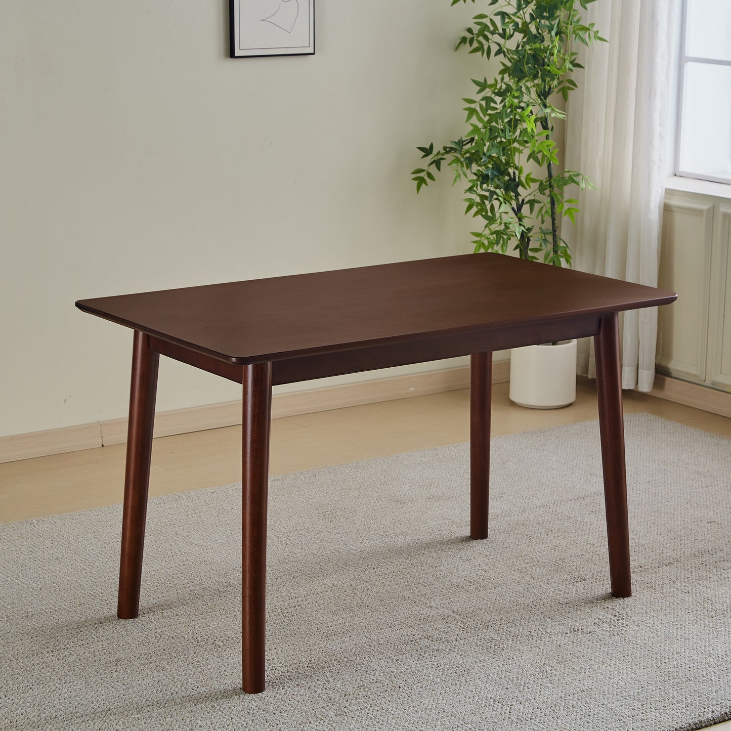 Dark wood dining table with rounded edges and tapered legs