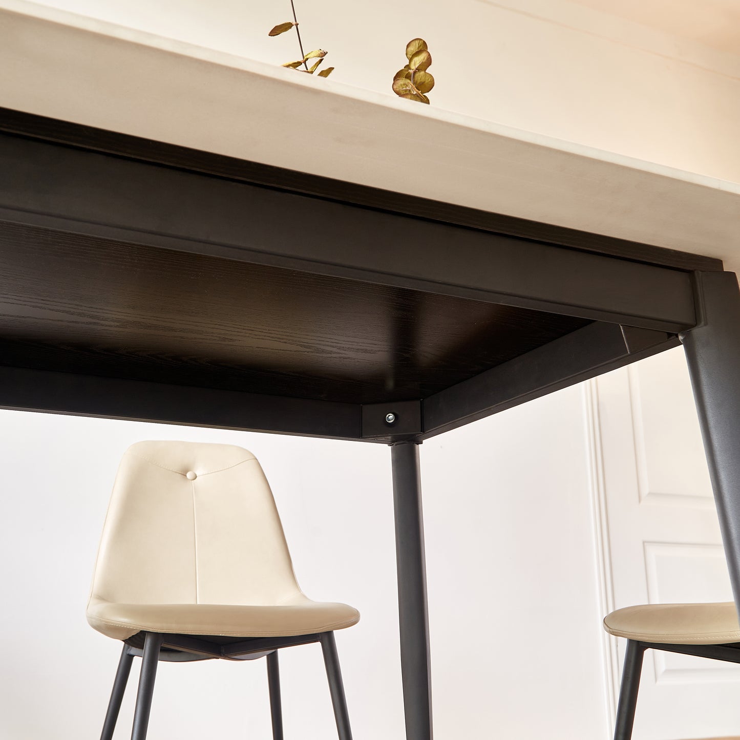 Cream tufted upholstered dining chair with black metal legs