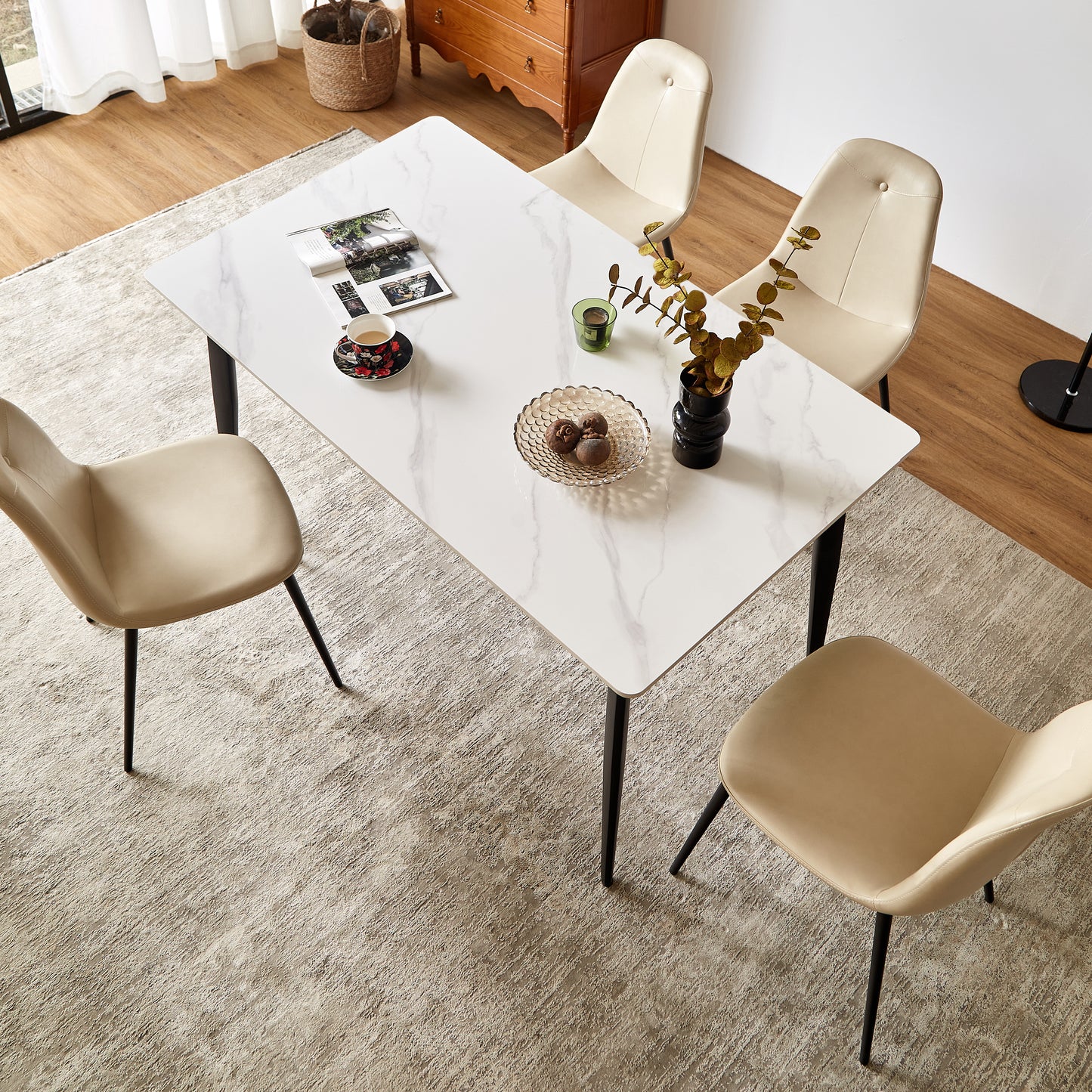 Modern white marble dining table with four cream upholstered chairs