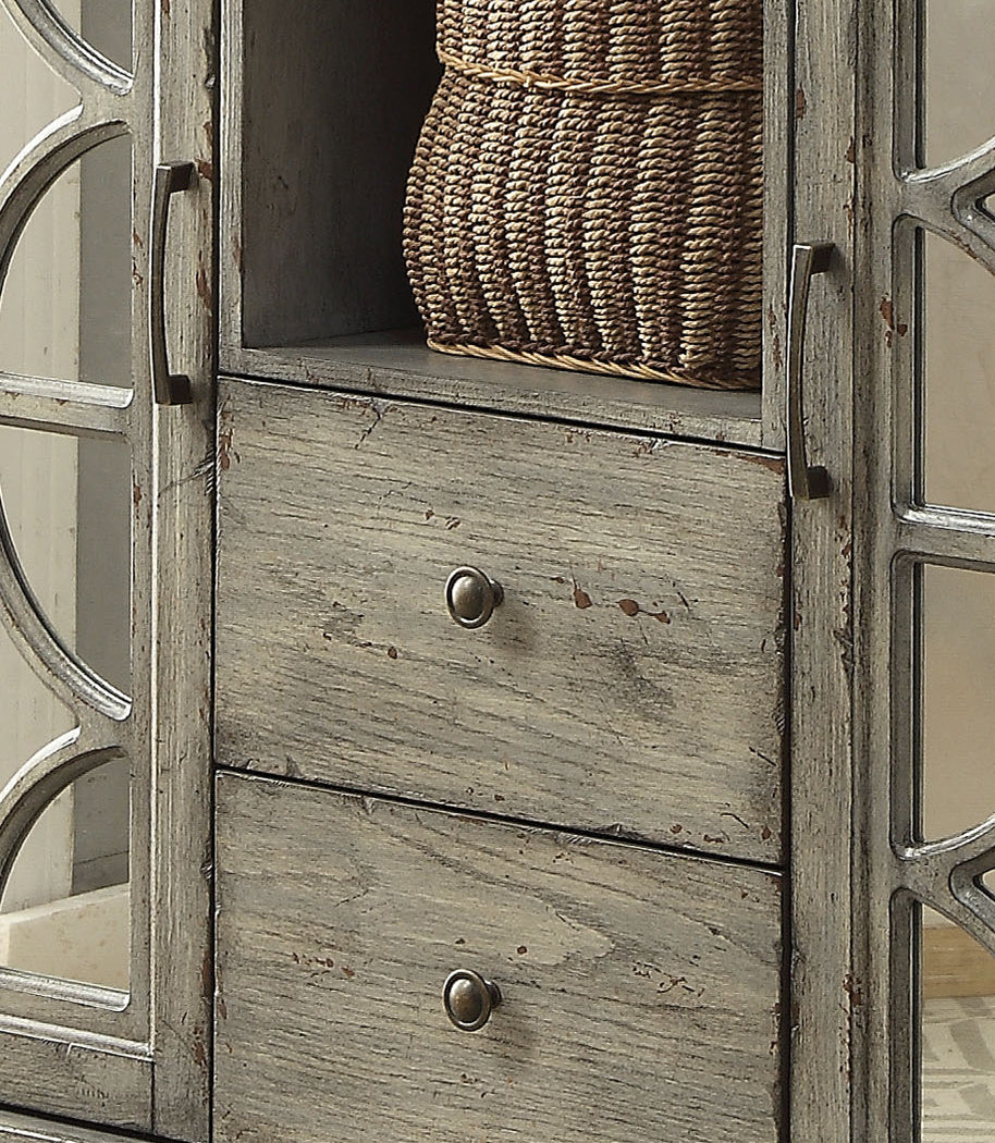 Distressed grey wood cabinet with mirrored glass doors and bronze knobs