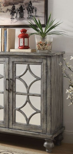 Grey distressed wood console table with mirrored geometric door panels