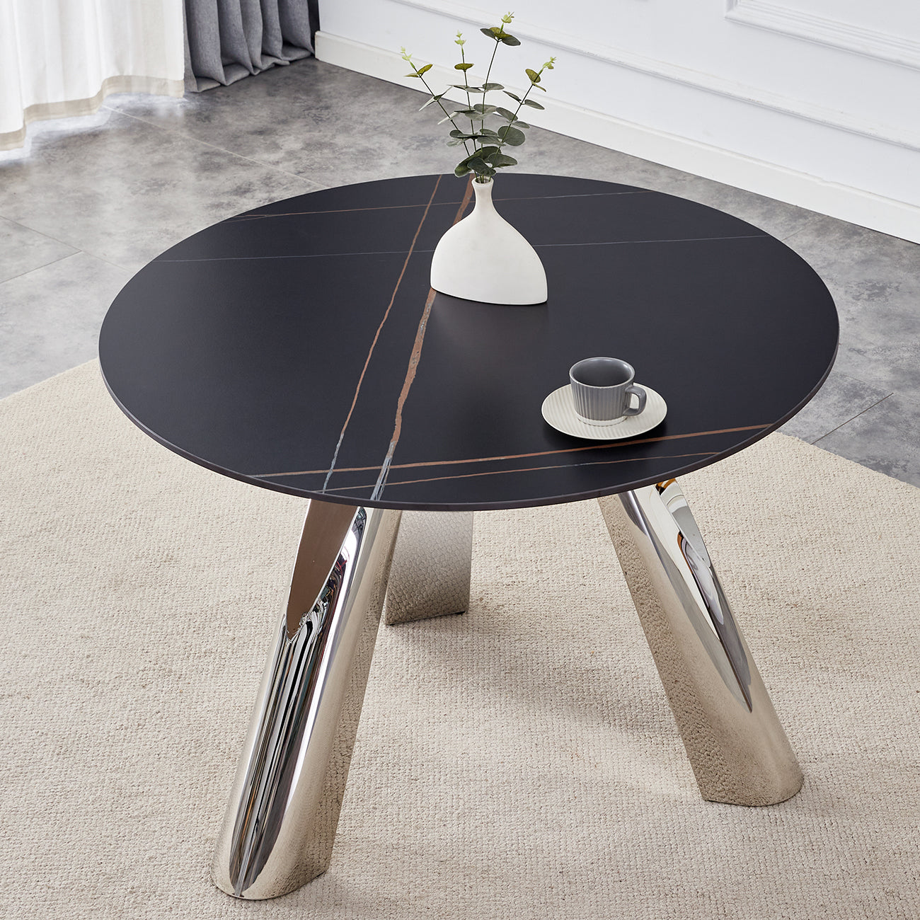Black round marble coffee table with chrome legs