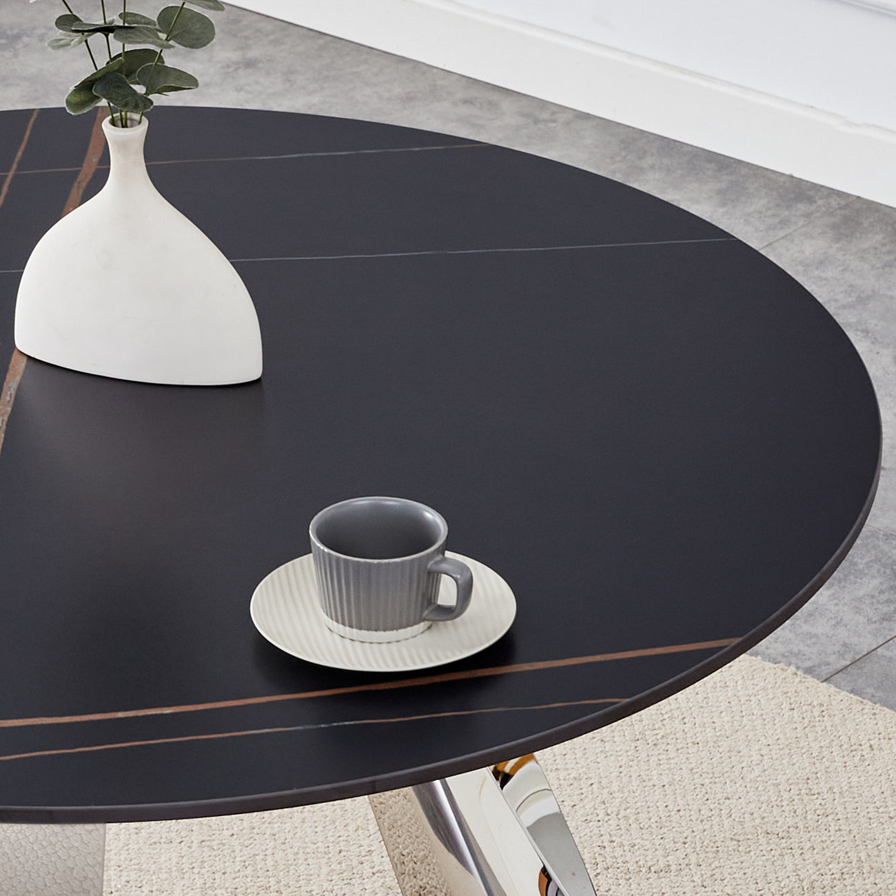 Modern black round dining table with metallic base and elegant marble inlay