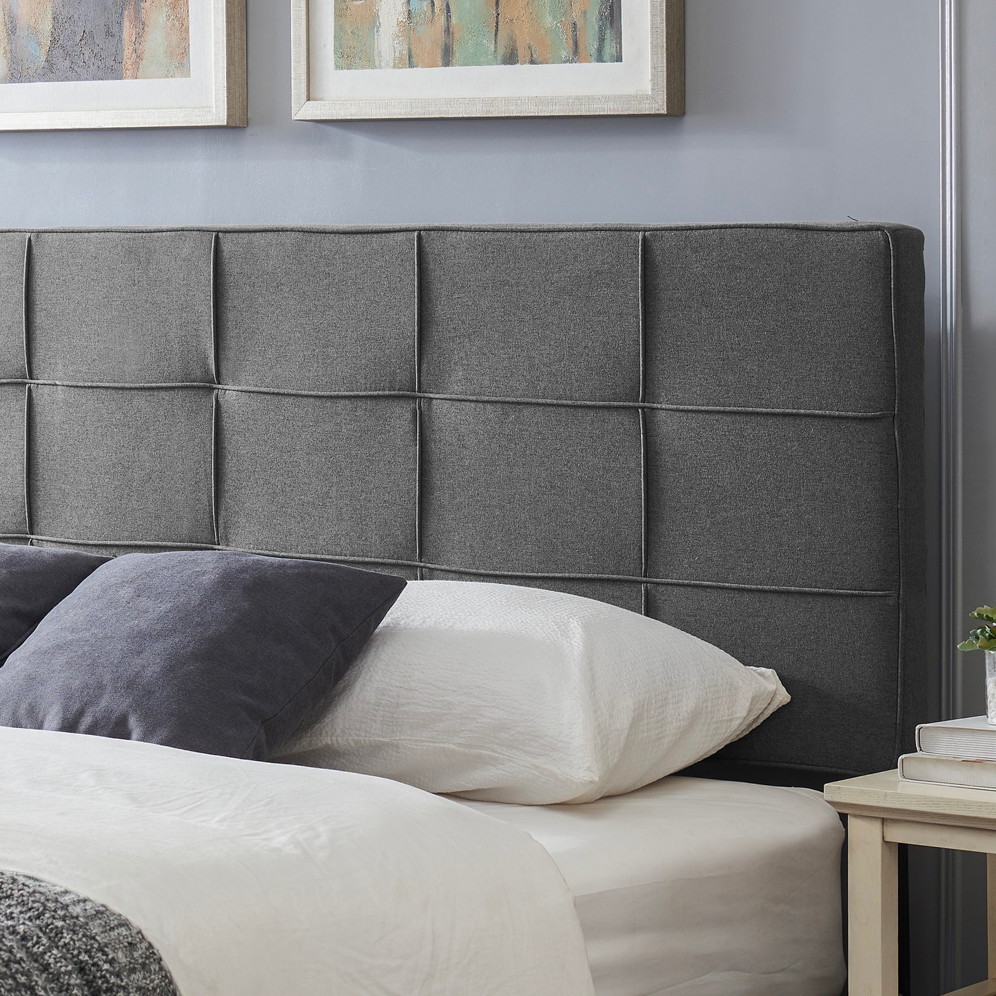 Tufted charcoal grey fabric headboard with square panel design
