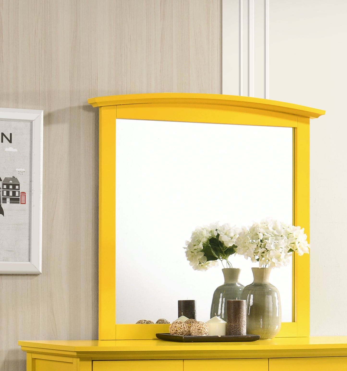 Vibrant yellow framed mirror with decorative vases and candles on a dresser