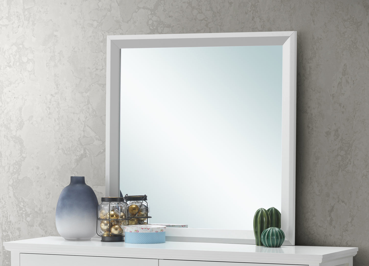 Modern white framed mirror with gradient blue vase and decorative cacti