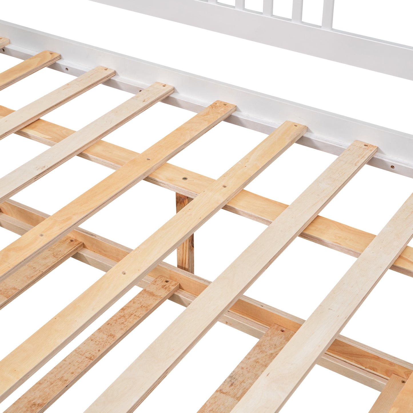 Closeup of a white wooden bed frame slat system