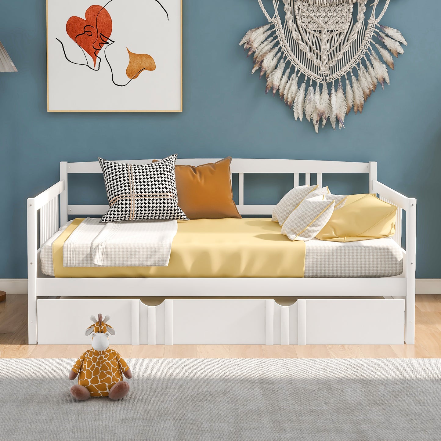 White wooden daybed with pullout drawers featuring yellow and grey bedding and decorative pillows