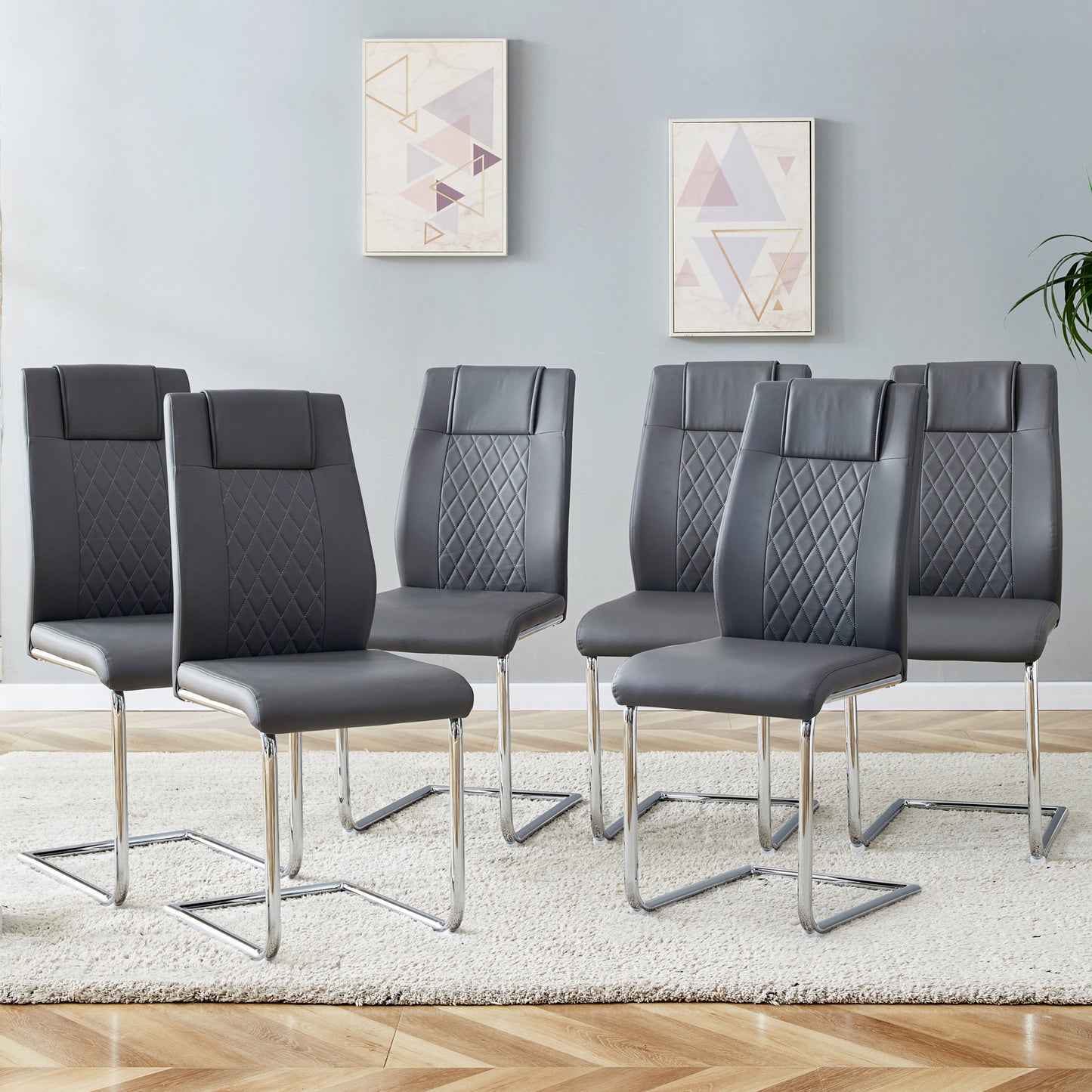 Set of dark grey faux leather dining chairs with diamond stitching