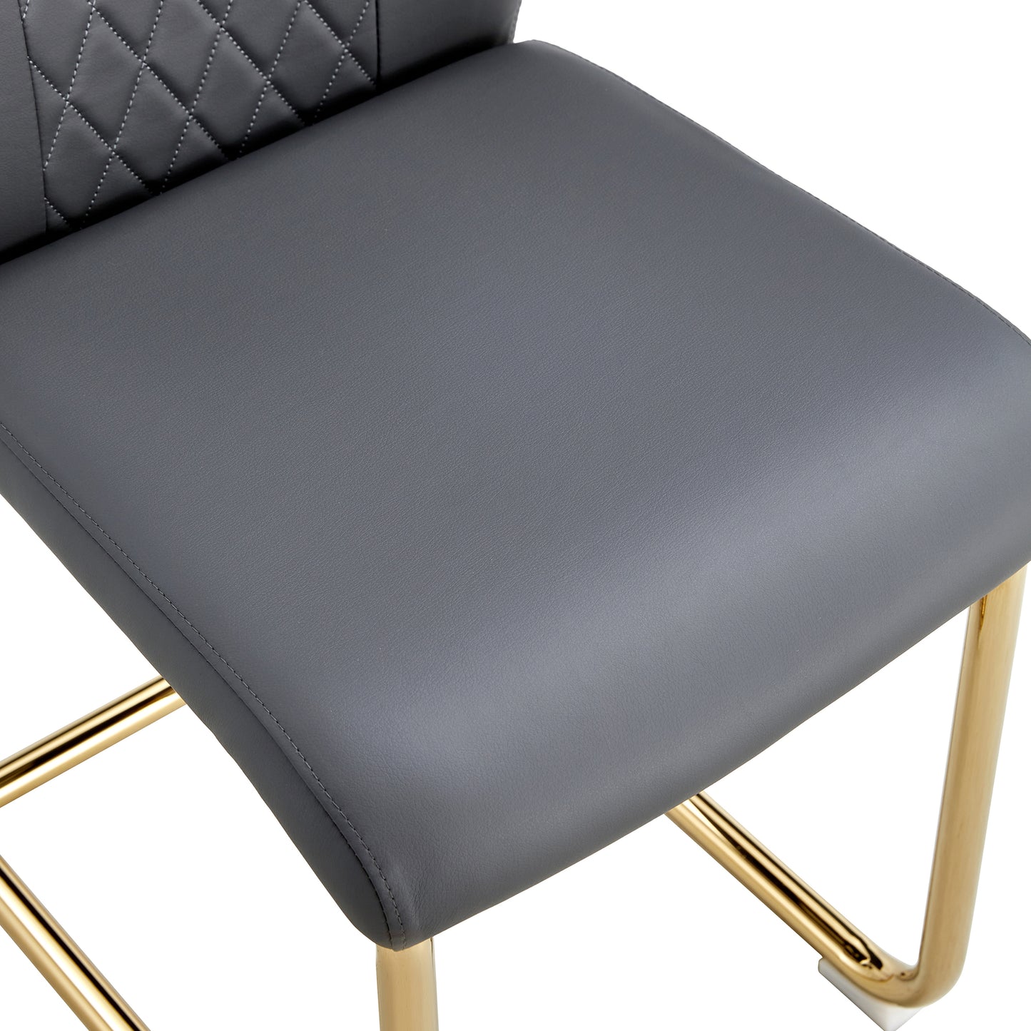 Closeup of a gray faux leather bar stool seat with diamond stitching and gold legs