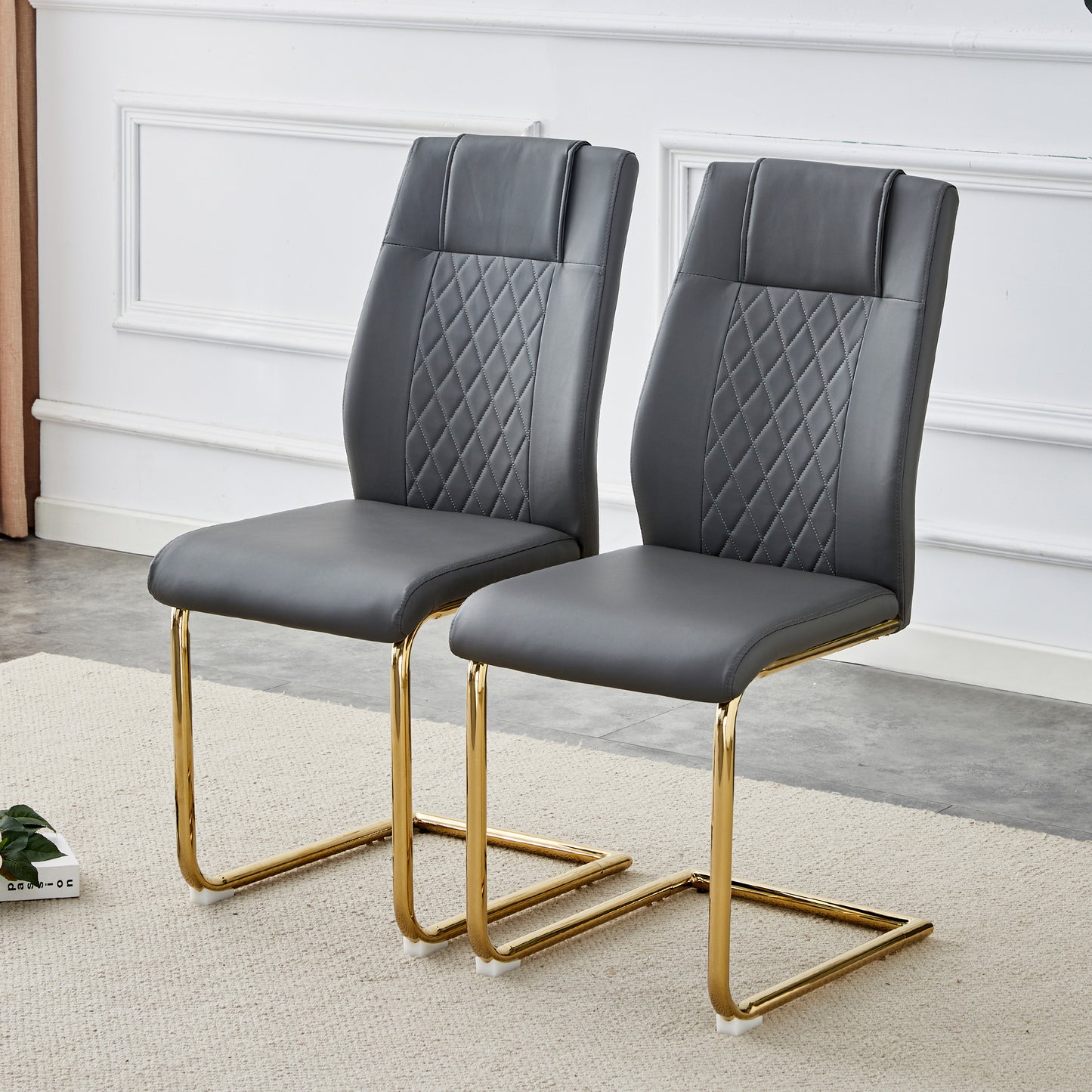 Modern gray faux leather dining chairs with diamond stitching and gold metal legs