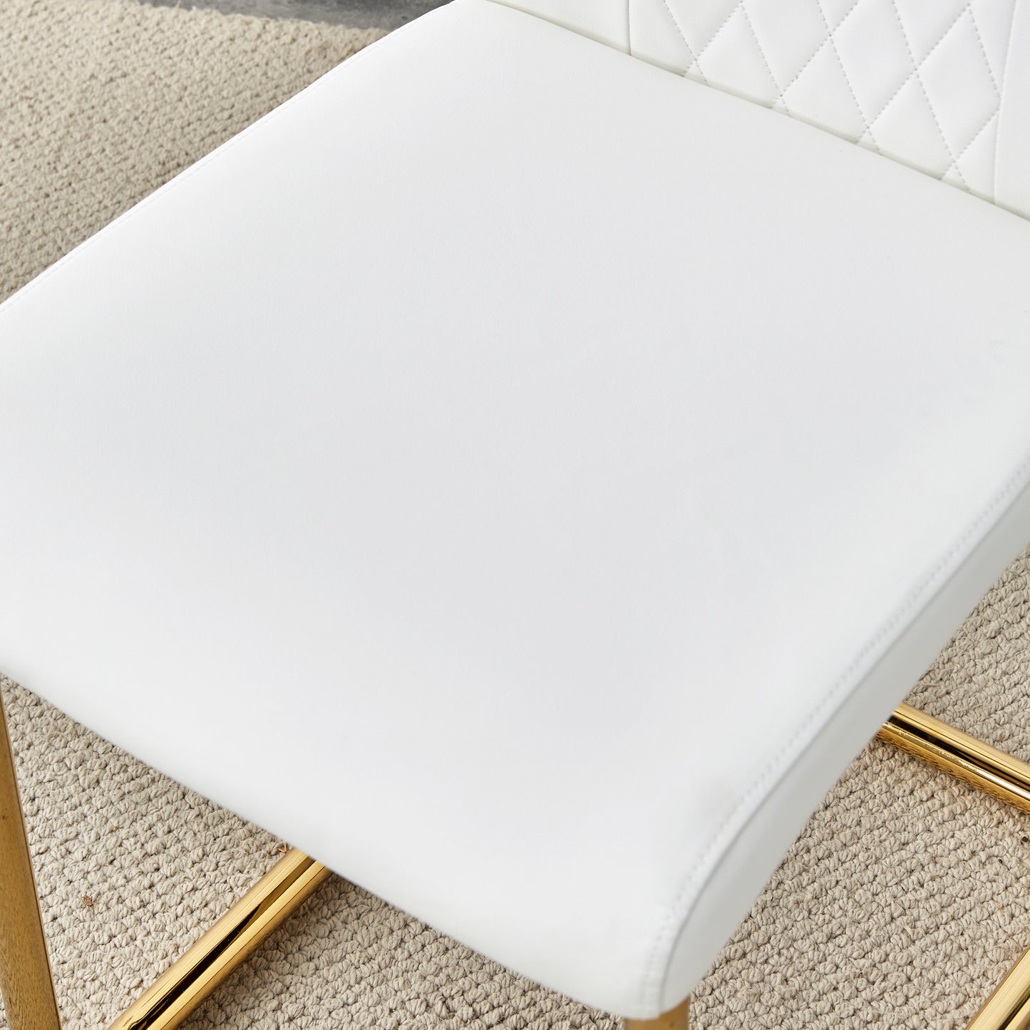 White faux leather bar stool with diamond tufting and gold legs