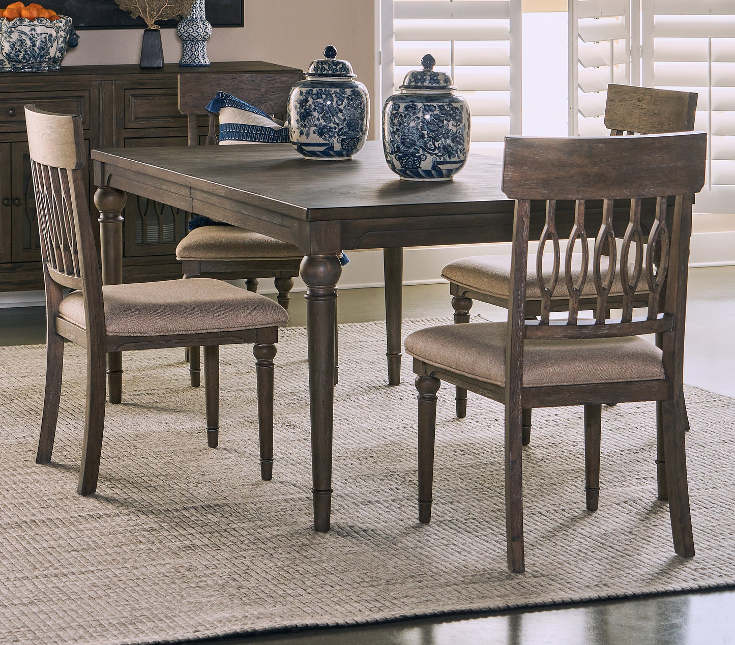 Dark oak dining table with upholstered chairs