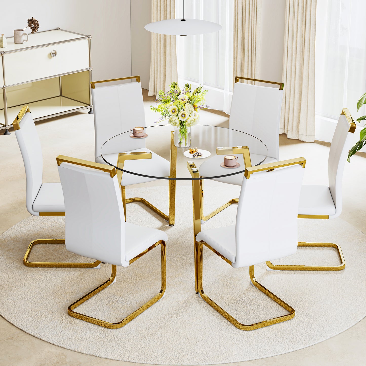 Modern white dining chairs with gold frames around a glasstop dining table