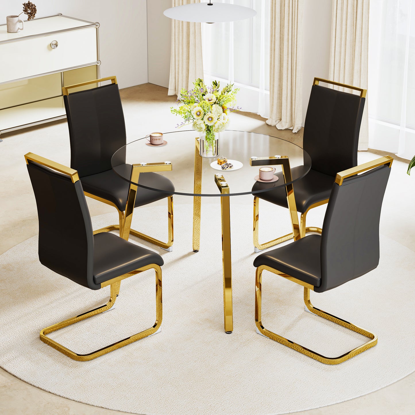 Black leather dining chairs with gold metal frames around a glass table