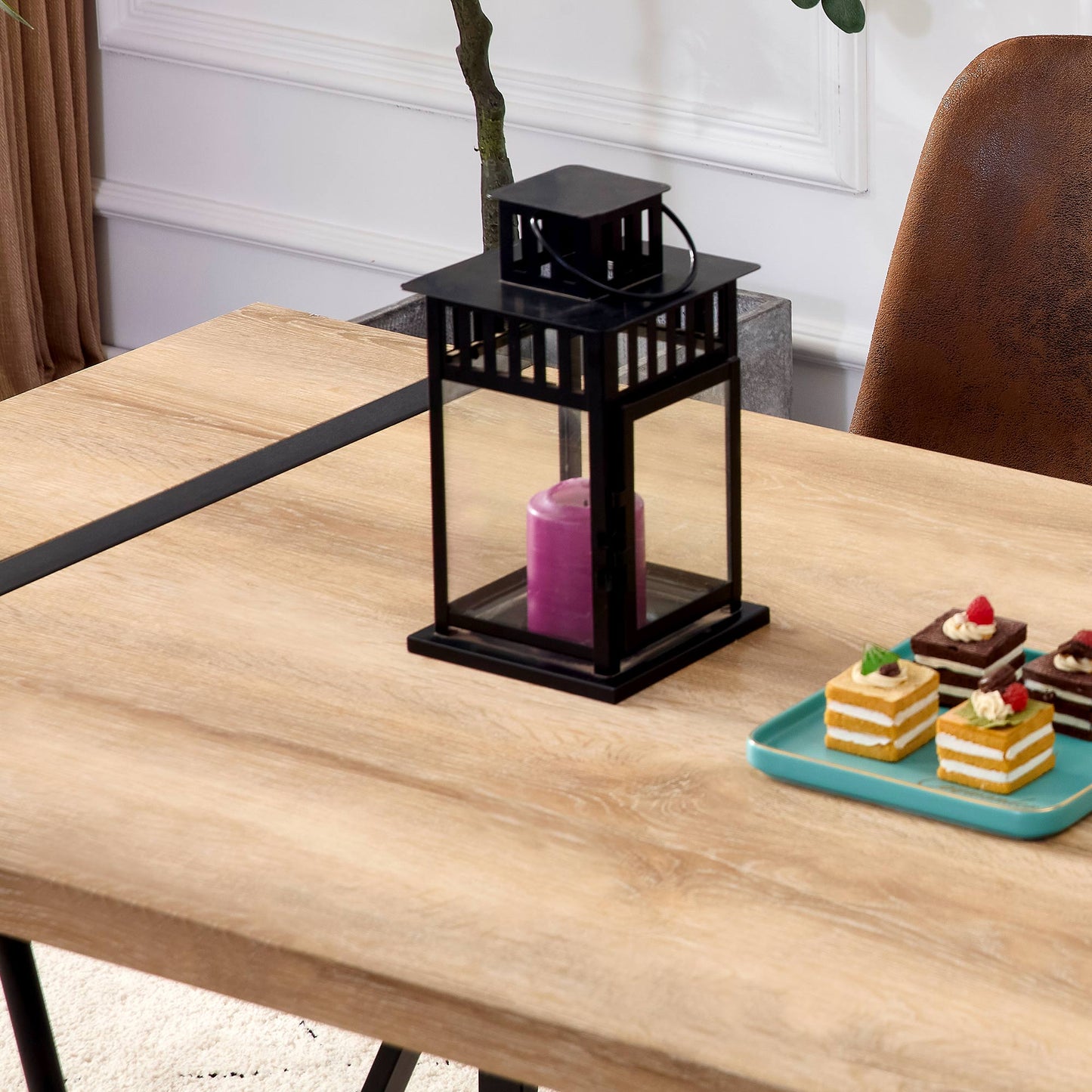 Black metal lantern with glass panels and a purple candle
